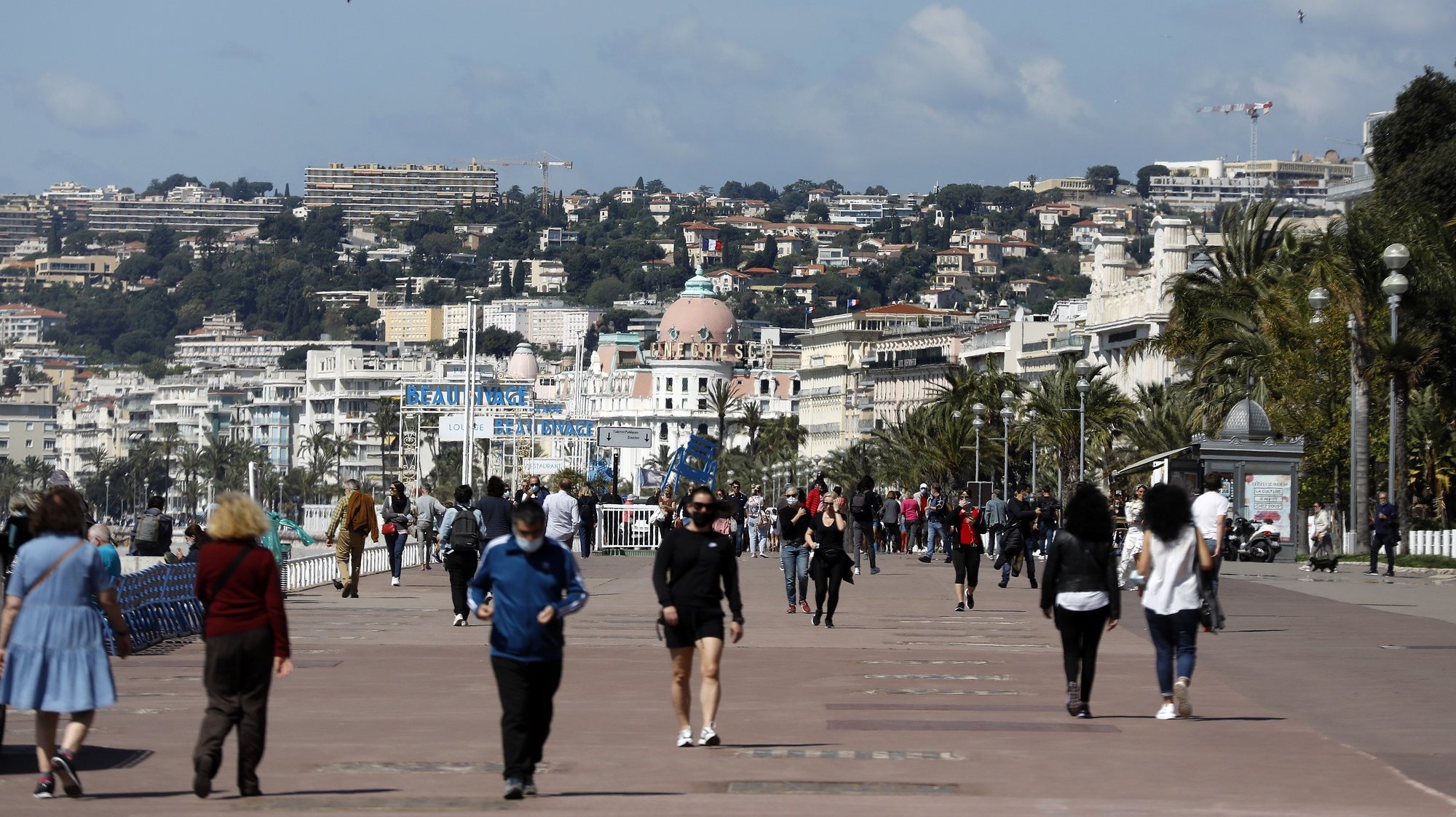 epa09175508 People walk on the &#039;Promenade des Anglais&#039; during the lockdown in Nice, France, 03 May 2021. French authorities on 03 May began a gradual easing of some of anti-covid measures, which include ending the 10Km domestic travelling restrictions.  EPA/SEBASTIEN NOGIER
