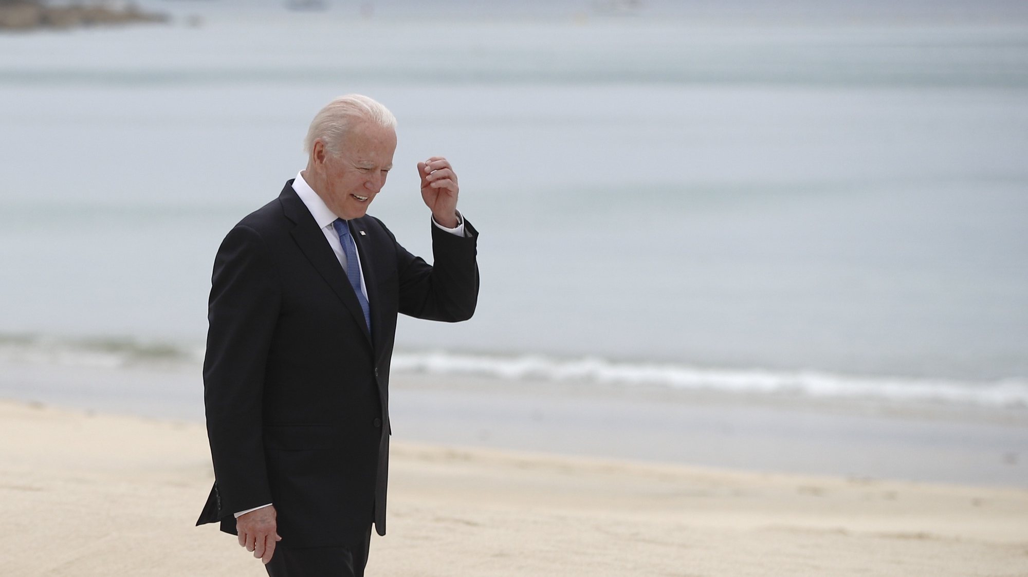 epa09262263 US President Joe Biden walks along the boardwalk during the G7 summit in Carbis Bay, Cornwall, Britain, 11 June 2021.  EPA/PHIL NOBLE / POOL