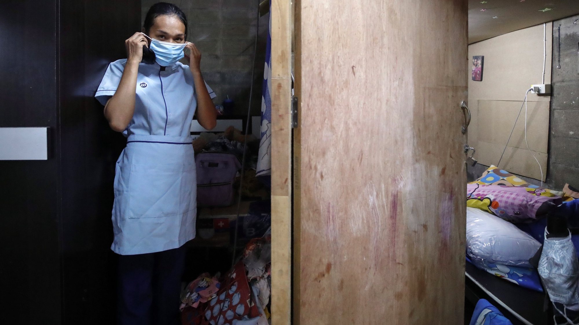 epa08495230 Wannisa Manatham puts on her protective mask at her home before leaving for work in Bangkok, Thailand, 23 May 2020 (issued 19 June 2020). In a neighborhood affected by crime and drug addiction, Wannisa faces economic drowning by Covid-19. Along with her uncle, Wannisa, who works as a cleaner in a hospital earning about 12,000 baht a month (about 376 dollars), is the only adult out of four in her family who have not lost their job to the pandemic. (about 376 US dollars). The pandemic has killed more men but it is women who are the most vulnerable to its socio-economic effects. Women often have to care for children, elderly and sick during lockdown. Many have not only lost their jobs but have been exposed to domestic violence as well as a widening in the gap of systematic inequality, especially in the poorest countries. UN Women warns in a report on the effects of Covid-19 that women do an average of 4.1 hours a day unpaid work such as housework or caring for dependents, three times as much as men. All the unpaid care carried out by women is equivalent to 2.35 percent of the global GDP or 1.35 trillion US dollars. In addition to occupying 70 percent of jobs in the health sector worldwide, women generally earn an average of 16 percent less than men, which rises to 35 percent in some countries.  EPA/DIEGO AZUBEL To go with EFE story by Gaspar Ruiz ATTENTION: This Image is part of a PHOTO SET