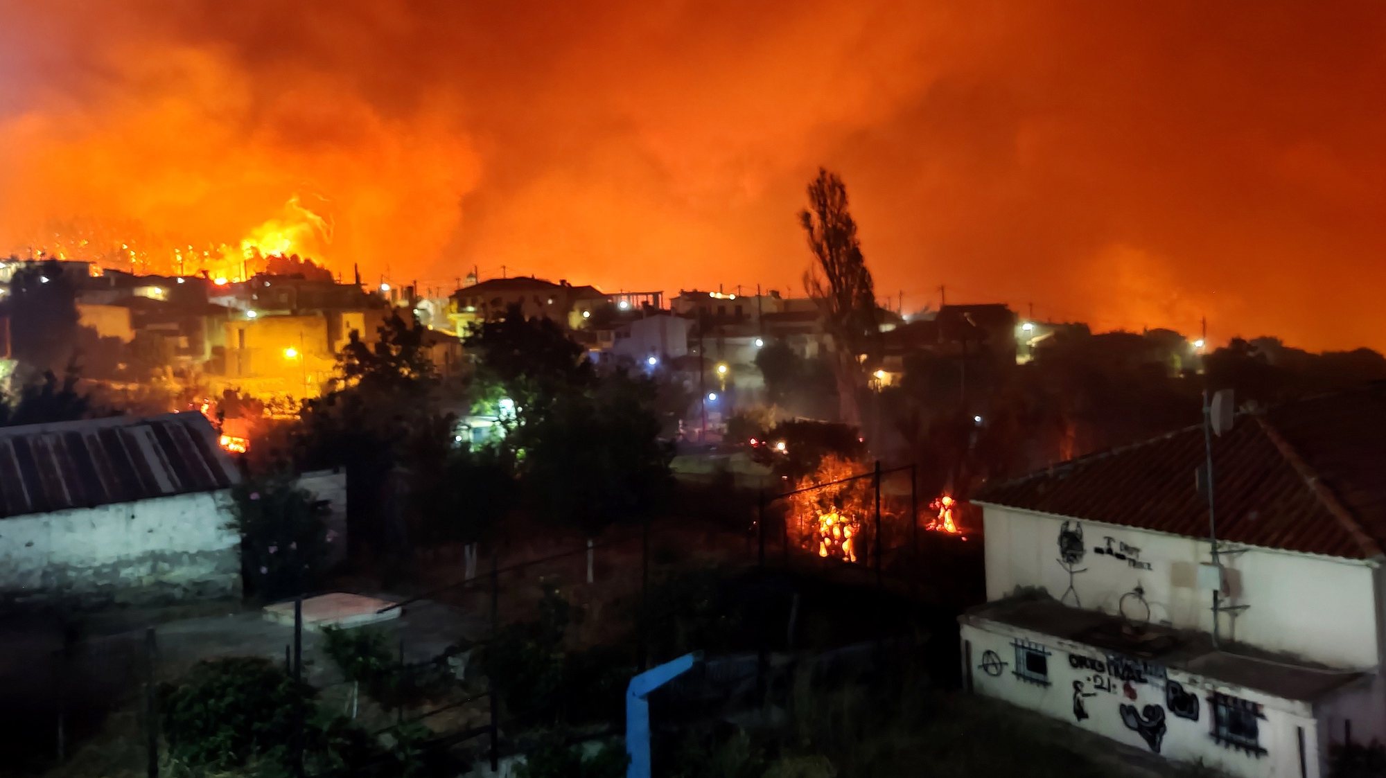epa09399808 Smoke and flames rise as a wildfire burns the area of Skepasti in Evia island, eastern coast of Central Greece, 05 August 2021 (issued 06 August 2021).The battle with the flames continued for a third consecutive day in north Evia, where various fronts had joined to form three massive fire fronts moving in different directions and moving toward the sea.The region of Central Greece announced that the villages Aghia Anna, Kerasia and Ahladi in northern Evia must be evacuated due to the raging fire in the area.  EPA/PANAGIOTIS KOUROS