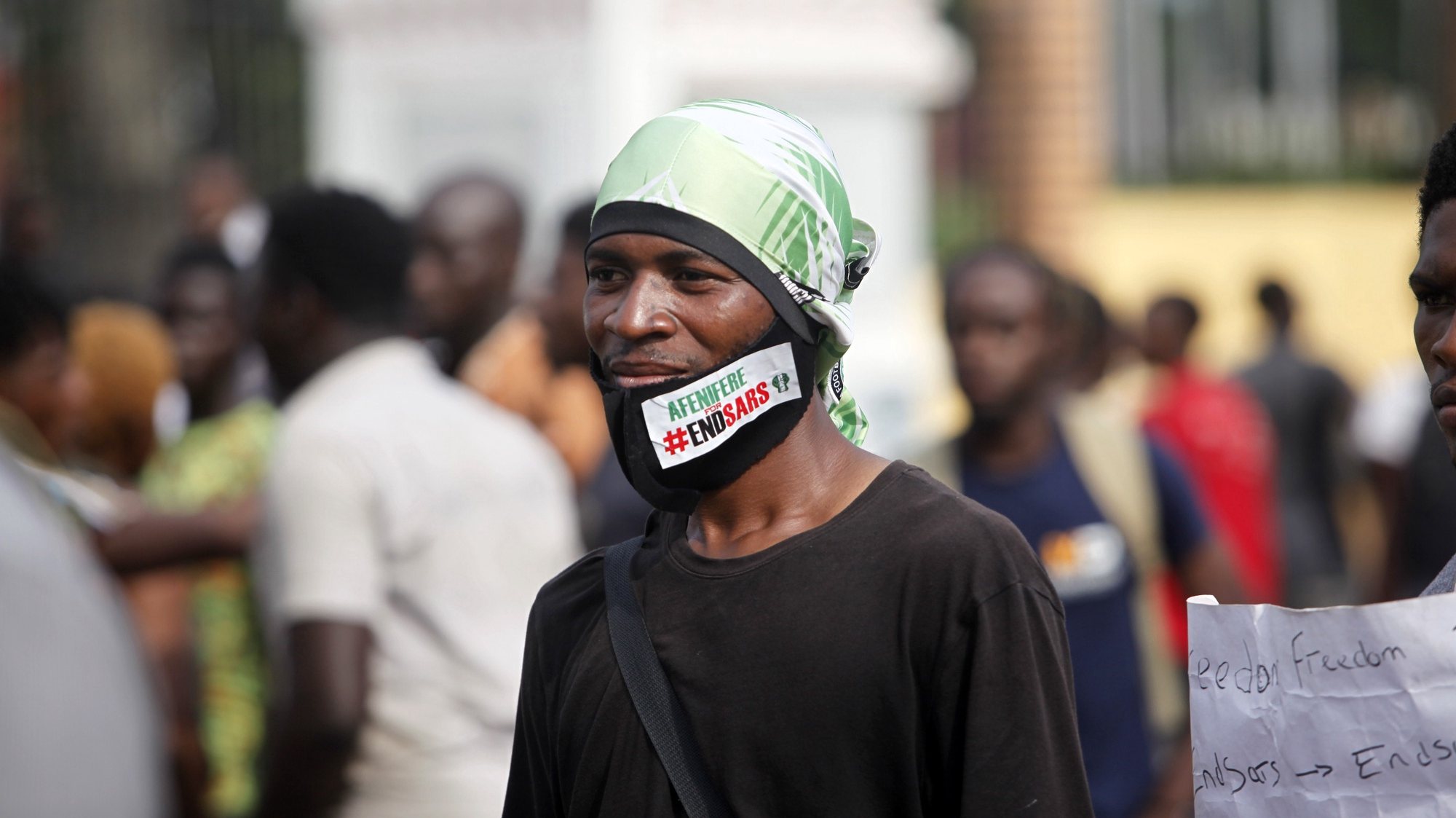 epa08760289 A protester wears a facemask with the inscription &#039;ENDSARS&#039; during a protest against the Nigeria rogue police, otherwise know as Special Anti-Robbery Squad (SARS), in Ikeja district of Lagos, Nigeria, 20 October 2020. It has been two weeks since the protests against SARS began and protesters say agitation against police brutality continues as an entry point to addressing other social and political issues such as corruption, official ineptitude to public accountability, and government inefficiency in Nigeria. The Lagos governor has imposed a 24-hour restriction on movement starting at four pm on 20 October in Lagos as protest begins to turn violent.  EPA/AKINTUNDE AKINLEYE