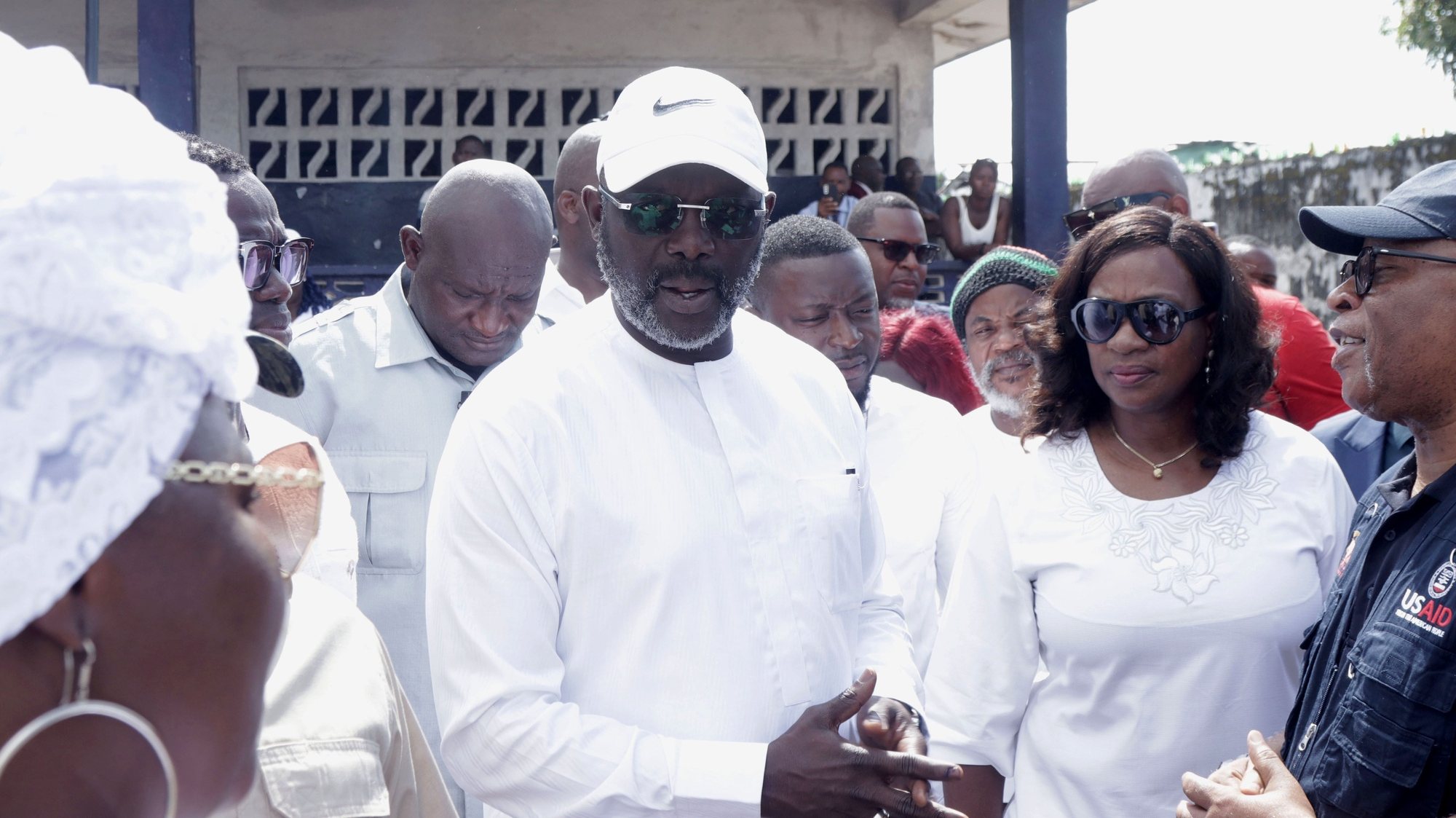 epa10974657 Liberian President George Weah (C), and First Lady, Clar Weah, during the presidential election at the Kendeja Public school in Paynesville, outside Monrovia, Liberia, 14 November 2023. Liberians are heading to the polls for a presidential runoff on 14 November, after the two leading candidates, President George Weah and opposition leader Joseph Boakai, failed to secure enough votes in the first round of voting on 10 October.  EPA/AHMED JALLANZO