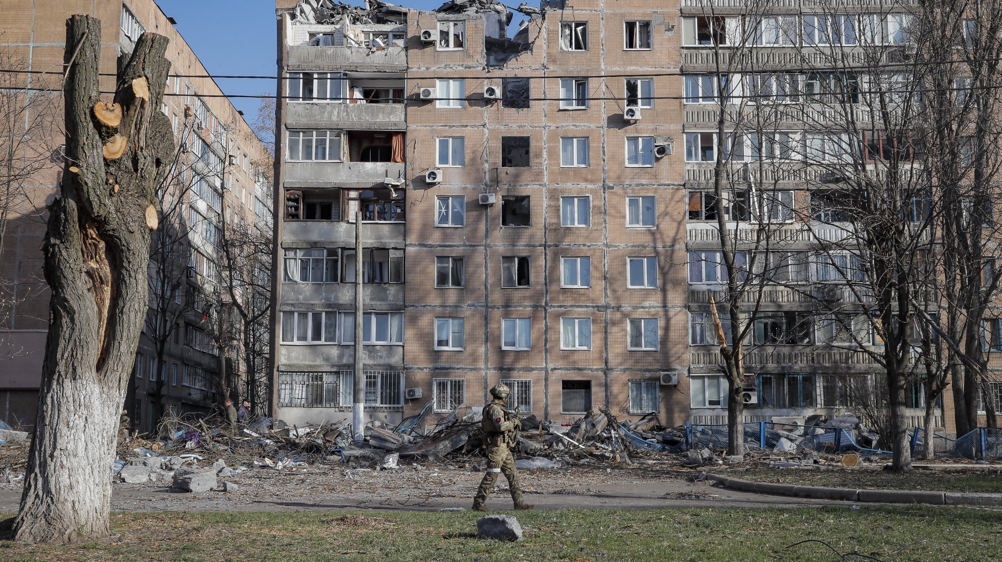 epa09884809 A Russian serviceman walks in front of destroyed apartment buildings in the shelling of two weeks ago by a &#039;Uragan&#039; missile, in Donetsk, Ukraine, 11 April 2022. In the self-proclaimed Donetsk People&#039;s Republic (DPR), 261 people died from 01 April to 07 April, the press service of the Commissioner for Human Rights in the republic reports. In total, 6,271 deaths have been registered in the DPR since the spring of 2014, including 96 children. On 24 February Russian troops had entered Ukrainian territory in what the Russian president declared a &#039;special military operation&#039;, resulting in fighting and destruction in the country, a huge flow of refugees, and multiple sanctions against Russia.  EPA/SERGEI ILNITSKY