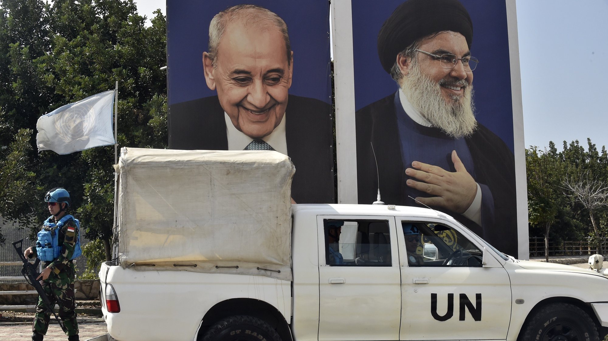 epa10909499 Soldiers of the UN peacekeeping mission, United Nations Interim Force In Lebanon (UNIFIL), stand guard next to posters of Lebanese Parliament Speaker Nabih Berri (L) and Hezbollah leader Hassan Nasrallah (R), in the village of Aadaysit, southern Lebanon, 09 October 2023. More than 700 Israelis were killed and over 2,000 were injured since the Islamist movement Hamas carried out an unprecedented attack on southern Israel on 07 October, the Israeli army said. According to Palestinian officials, more than 500 people were killed and nearly 3,000 were injured as a result of Israel’s retaliatory raids and air strikes in the Palestinian enclave.  EPA/WAEL HAMZEH