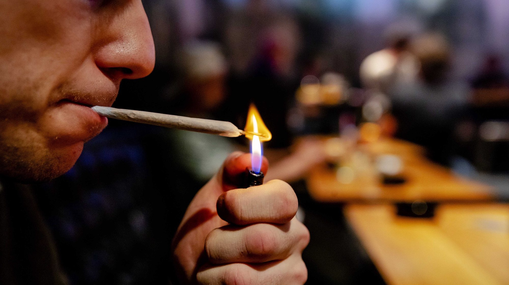 epa07523289 A man lights a weed joint in Cremers coffee shop, in The Hague, the Netherlands, 22 April 2019 (issued 23 April 2019). In the Netherlands, an experiment with state-regulated marijuana cultivation is starting. The aim of the experiment is to show whether weed can be removed from crime, but also what the use of cannabis means for health.  EPA/ROBIN VAN LONKHUIJSEN  ATTENTION: This Image is part of a PHOTO SET