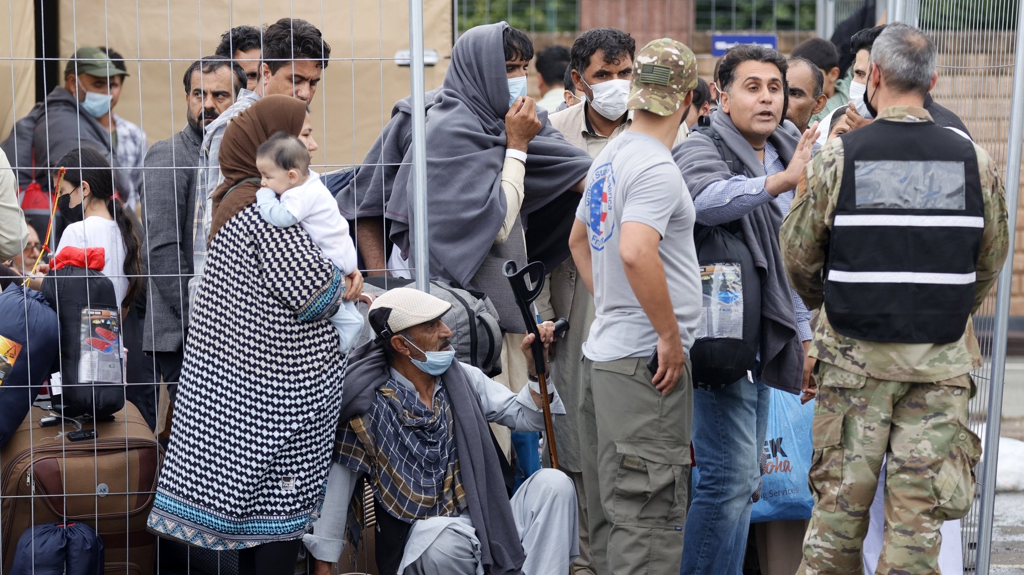 epa09436904 Evacuees from Afghanistan wait at the US Air Base in Ramstein, Germany, 30 August 2021. Ramstein Air Base is serving as major hub in the operation to evacuate people from Afghanistan, as the site is the world&#039;s largest US air force base outside the United States of America.  As part of Operation Allies Refuge, evacuees will receive support such as temporary lodging, food and water and access to medical care as well as religious care at Ramstein Air Base while preparing for onward movements to their final destinations. This operation is facilitating the quick, safe evacuation of US citizens, Special Immigrant Visa applicants, and other at-risk Afghans from Afghanistan.  EPA/RONALD WITTEK