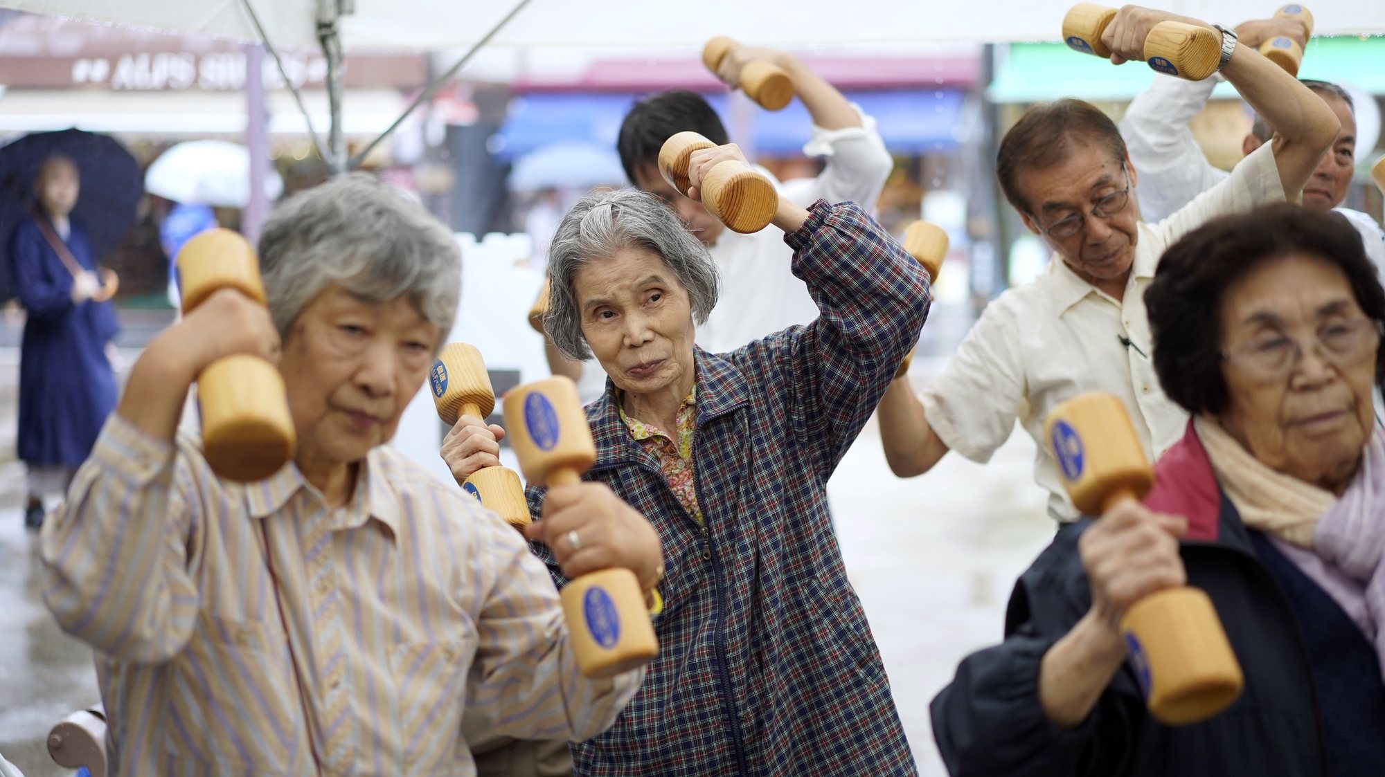 epaselect epa07845862 Elderly people practice physical activity with wooden dumbbells during an event marking the &#039;Respect for the Aged Day&#039; in Tokyo, Japan, 16 September 2019. According to government data released on 15 September, 35.88 million people are aged 65 or older in Japan, representing a record 28.4 percent of the population. Japan has the oldest population in the world.  EPA/FRANCK ROBICHON