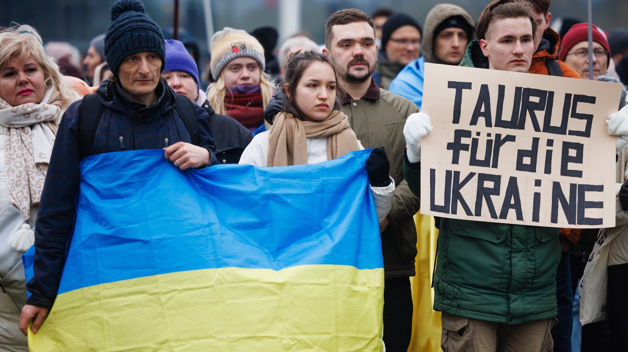 epa11061140 A participant holds a placard reading &#039;Taurus for Ukraine&#039;, asking for delivery of the Taurus cruise missile system to Ukraine, while others display an Ukrainian national flag during a rally to show solidarity with Ukraine in front of the Chancellery in Berlin, Germany, 06 January 2024. Under the motto &#039;Support Ukraine&#039;, the rally held in front of the German Chancellery on 06 January called for more support of Ukraine amid the ongoing Russia-Ukraine conflict.  EPA/CLEMENS BILAN