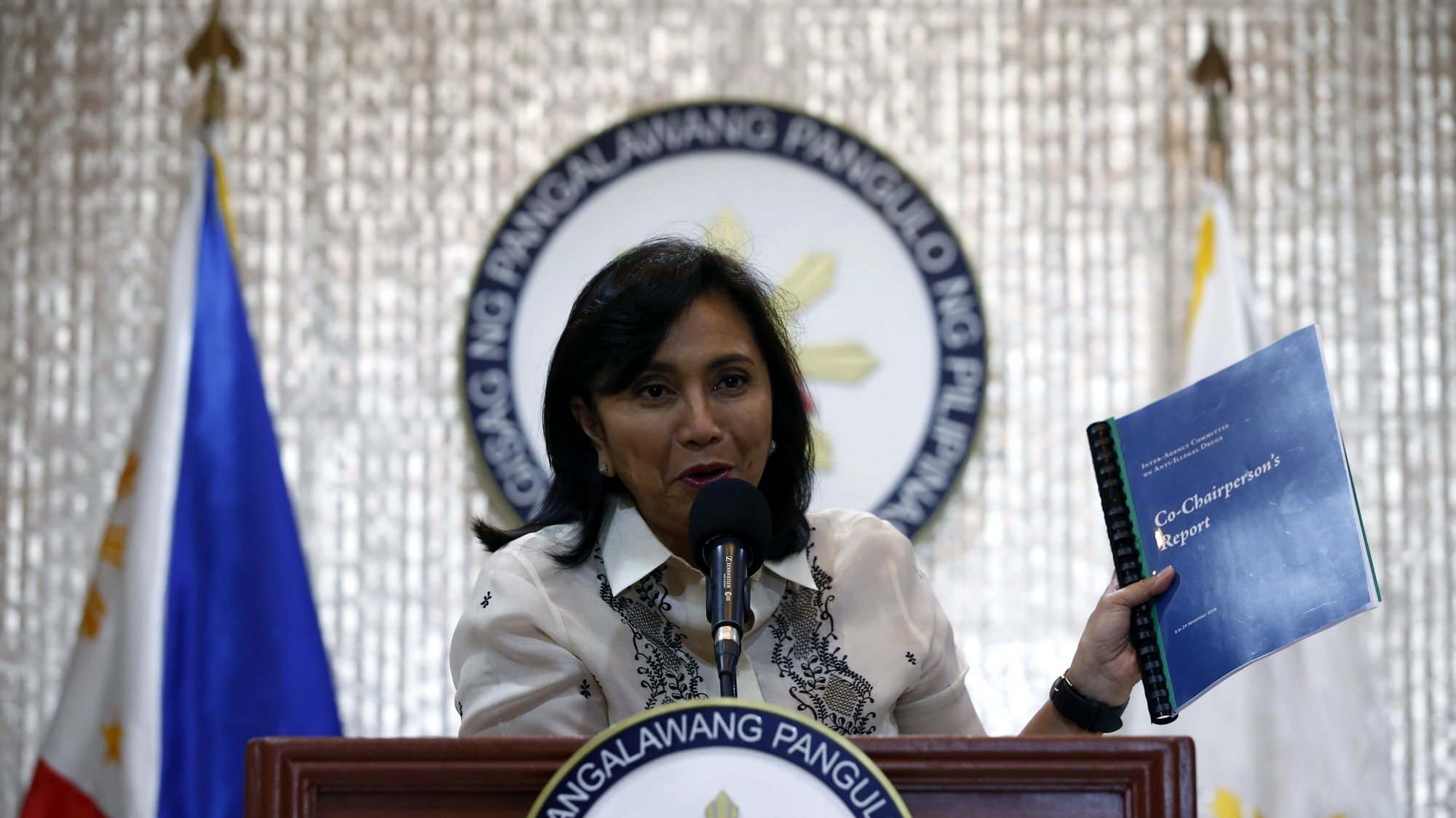 epa08074764 Philippine Vice President Leni Robredo shows a copy of her report, which was compiled from her short stint as co-chair of the country&#039;s Inter-Agency Committee on Anti-Illegal Drugs, at a press conference in Quezon City, Philippines, 16 December 2019. Robredo, who was barely a month into the position of co-chair when President Rodrigo Duterte removed her, deferred releasing details of her report on the country&#039;s illegal drugs situation and instead called for unity in helping people affected by the 6.9-magnitude earthquake that hit parts of the southern Philippines on 15 December.  EPA/ROLEX DELA PENA