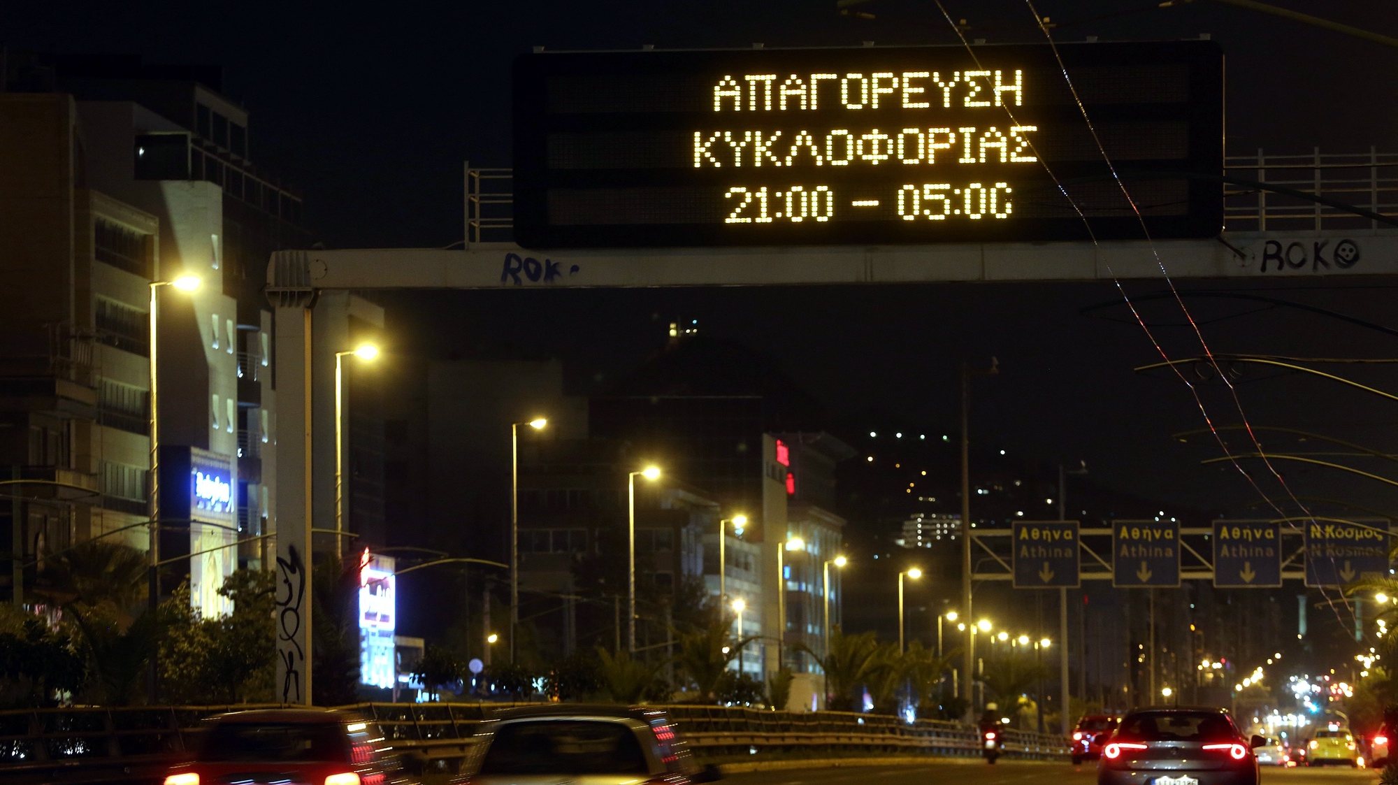 epa08819095 An illuminated sign over an Athens highway reminds drivers of an overnight curfew, Greece, 13 November 2020. An overnight curfew, starting on 13 November, will come into effect across the country between 21:00 and 05:00 everyday, with specific exceptions - work, health and walking pets, to stem the spread of the Covid-19 coronavirus pandemic. Greece is currently observing a nationwide lockdown that went into effect on 07 November and will remain effective through 30 November. During this time, citizens must request a permit for their outings, issued via SMS messaging.  EPA/ALEXANDROS BELTES