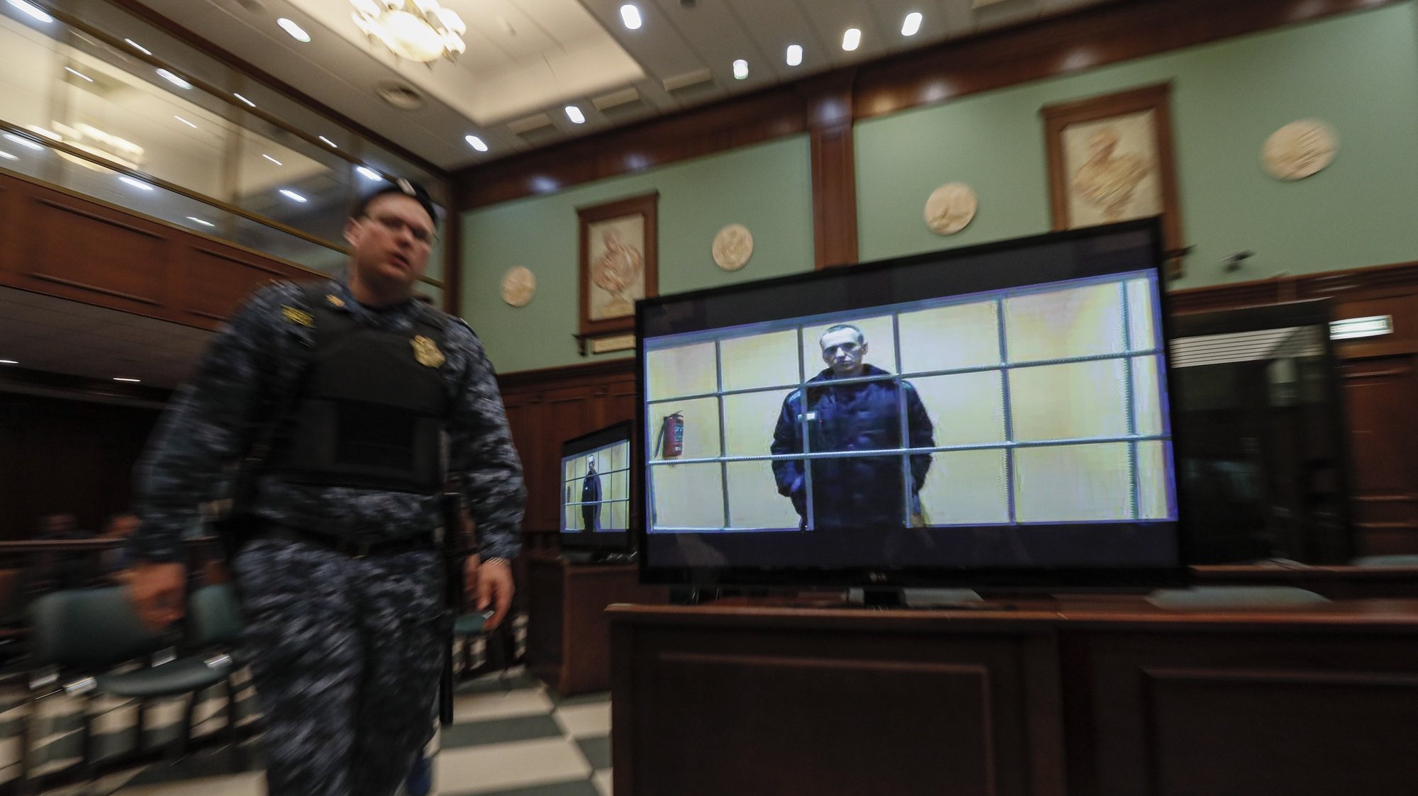 epa09971356 Russian opposition leader Alexei Navalny is shown on a monitor screen via video link from the penal colony No. 2 (IK-2) in Pokrov in Vladimir region, during a hearing of an appeal against Lefortovsky court sentence at the Moscow city court in Moscow, Russia, 24 May 2022. The Lefortovsky court sentenced politician Alexei Navalny to nine years in a strict regime colony and a fine of 1.2 million rubles for large-scale fraud and insulting the court. The Moscow city court upholded Navalny&#039;s conviction.  EPA/YURI KOCHETKOV