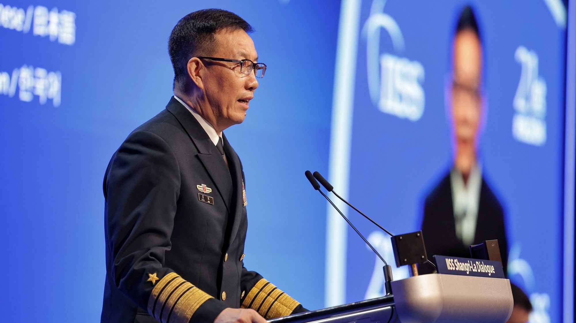 epa11384962 China&#039;s Minister of National Defence Admiral Dong Jun delivers his speech during a plenary session of the International Institute for Strategic Studies (IISS) 21th Shangri-La Dialogue in Singapore, 02 June 2024. Defense ministers and officials from 45 countries are gathered in the city state for the IISS Shangri-la Dialogue, an annual high level defence summit in the Asia Pacific region.  EPA/KEVIN LIM/THE STRAITS TIMES SINGAPORE OUT HANDOUT EDITORIAL USE ONLY/NO SALES HANDOUT EDITORIAL USE ONLY/NO SALES