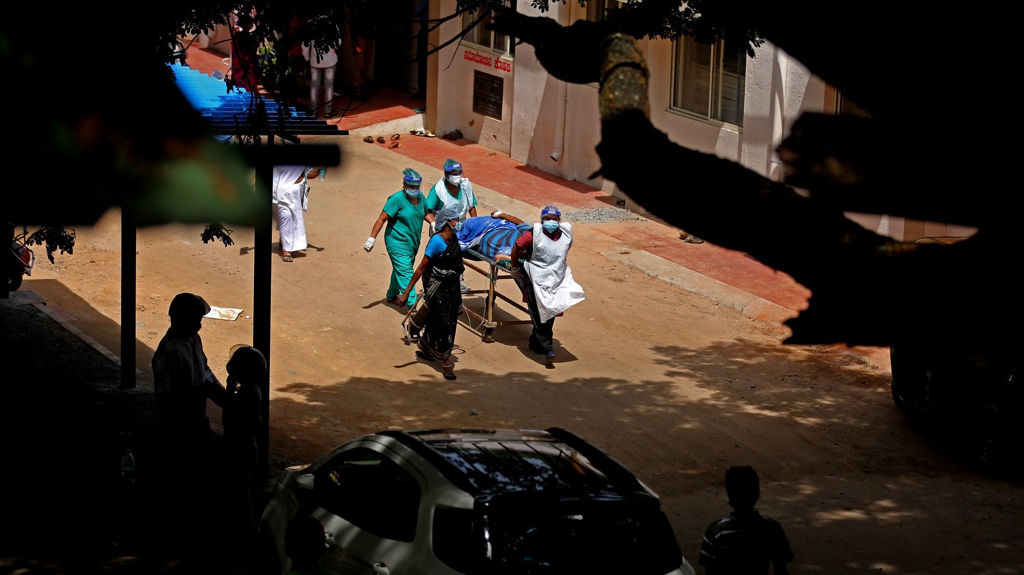 epa09225252 Health officials bring a suspected COVID-19 patient at KC General hospital in Bangalore, India, 24 May 2021. Mucormycosis, also known as `back fungus’, is caused by exposure to mucor mold, which is commonly found in soil, air and even in the nose and mucus of humans. It spreads through the respiratory tract and erodes facial structures. Health authorities asked many states to track the spread of the disease and declare it an epidemic.  EPA/JAGADEESH NV