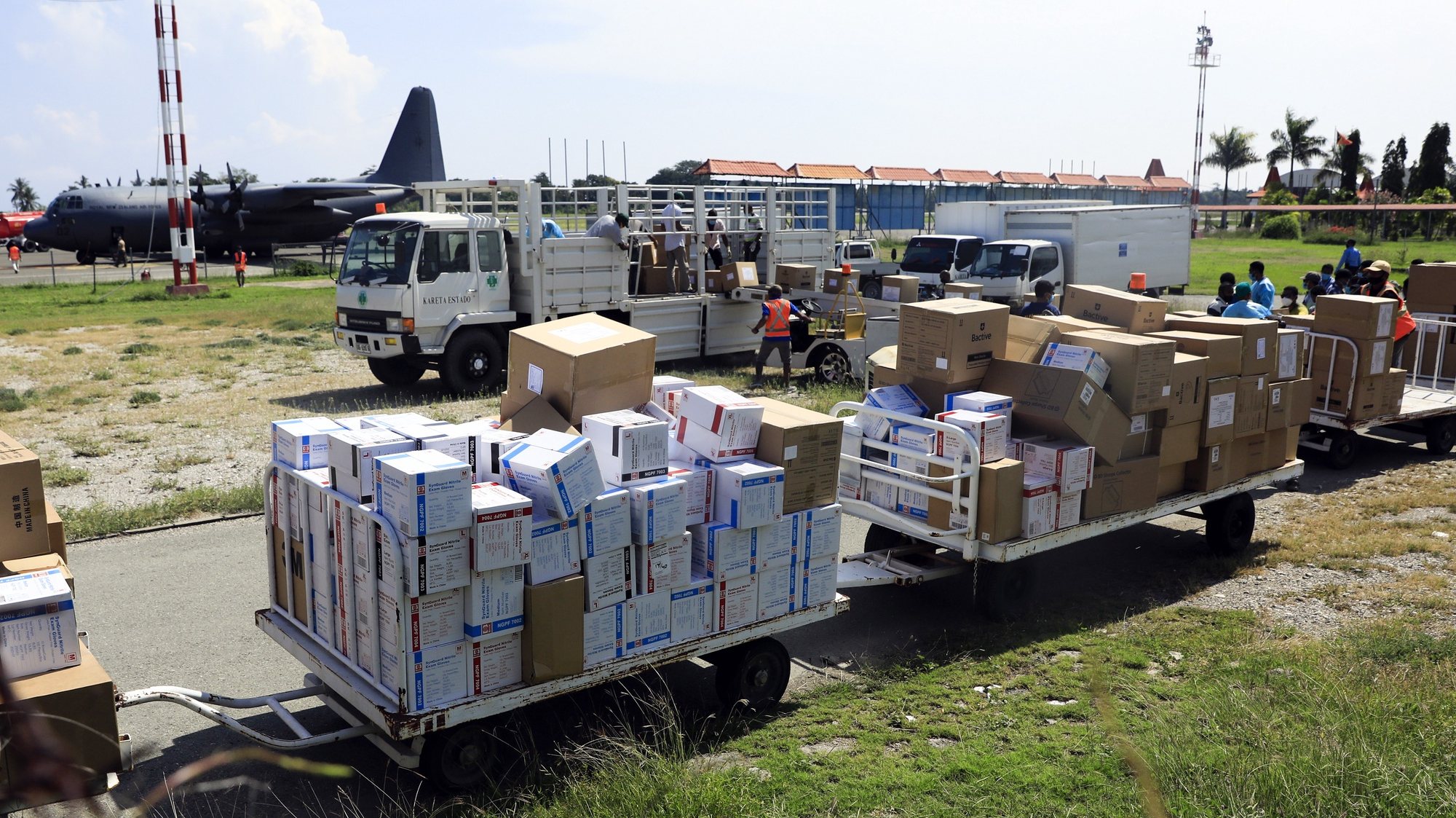 epa09090833 Workers unload medical supplies, donated by New Zealand to help in the treatment of COVID-19 patients, from a military aircraft at President Nicolau Lobato International Airport in Dili, East Timor, also known as Timor Leste, 23 March 2021. With less than 300 COVID-19 cases and zero deaths, Timor Leste recorded the second smallest outbreak in Southeast Asia after Laos.  EPA/ANTONIO DASIPARU