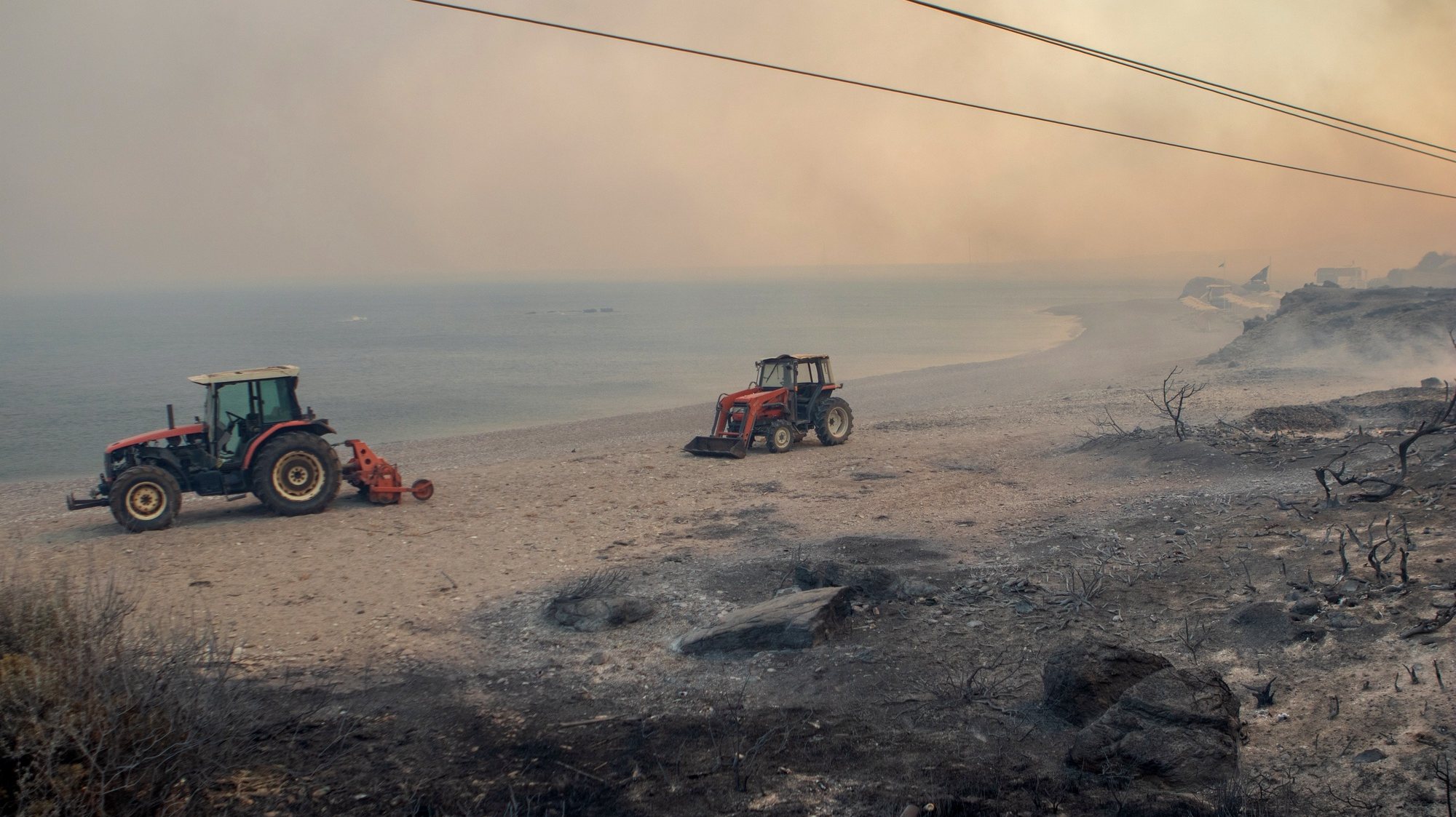 epaselect epa10762717 Τractors operate during a wildfire in Kiotari village, on Rhodes island, Greece, 22 July 2023. Although the Fire Department had managed to put out several rekindled blazes on the island over the last few days, the wildfire near the village of Laerma in the island&#039;s north keeps expanding and moving eastwards to the Gadoura dam, while residents in the villages of Lardos and Pilonas were told to evacuated their homes on the day, via the emergency number 112. Some 173 firefighters with 35 fire engines and 10 ground teams are battling the blaze, assisted by 3 water bombers and 2 helicopters. Another 31 firefighters with 4 fire engines and 3 ground teams were also expected to arrive from Slovakia. Local authority water tanks are also helping out.  EPA/DAMIANIDIS LEFTERIS