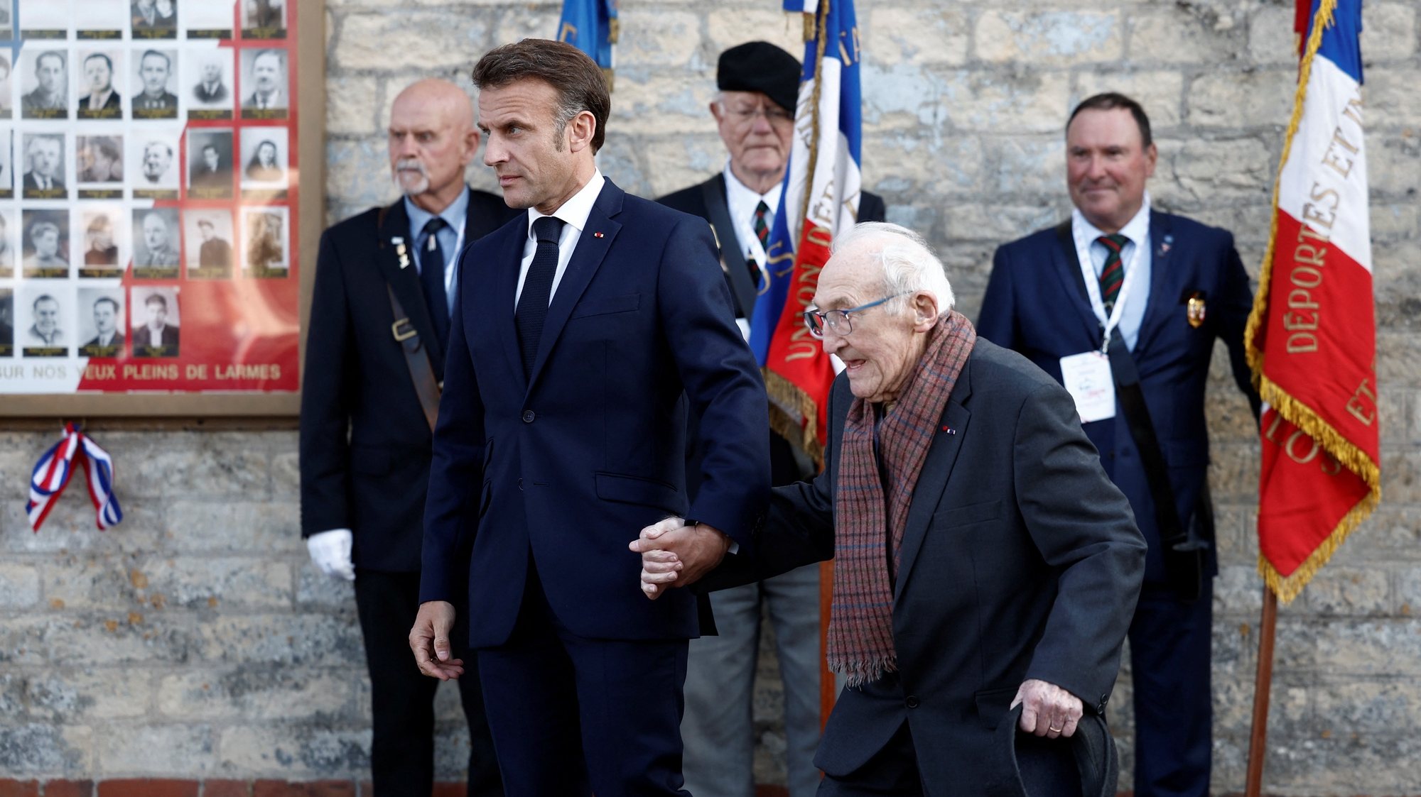epa11391884 French President Emmanuel Macron holds the hand of Bernard Duval, a survivor of the 1944 Caen prison massacre, during a ceremony at the Caen prison to pay tribute to French Resistance fighters in Caen, north-western France, 05 June 2024. French President Macron launched the commemoration of the 80th anniversary of D-Day, the Normandy landings of Western Allied forces on 06 June 1944 that initiated the liberation of western Europe during World War II, by paying tribute to the French Resistance fighters.  EPA/BENOIT TESSIER / POOL  MAXPPP OUT