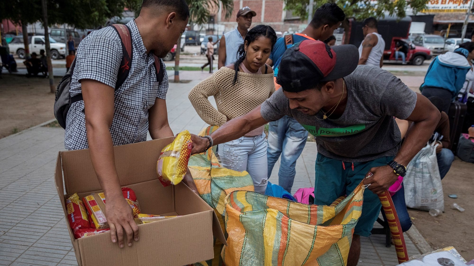 epa07992976 Two men arrange boxes with food in the Colombian city of Cucuta, near of border with Venezuela, 12 October 2019 (issued on 13 November 2019). Each weekend, several thousand people leave Caracas and other Venezuelan cities to Cucuta to buy essential items like flour, pasta, soap or sausage to bring them back to their homes. According to Colombian Migration Director, Cristian Krueger, some four million Venezuelan people cross the border to buy inside their country in a phenomenon known as &#039;pendulous migration&#039;.  EPA/Rayner Pena R.