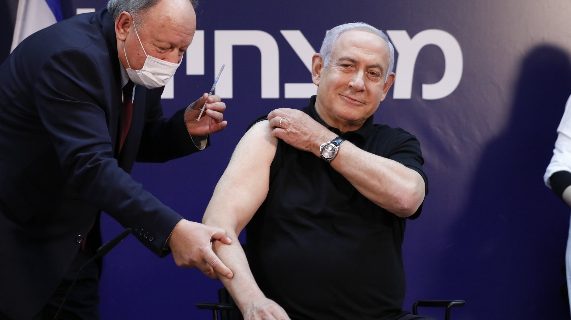 epa08894574 Israeli Prime Minister Minister Benjamin Netanyahu (R) receives a coronavirus disease (COVID-19) vaccine at Sheba Medical Center in Ramat Gan, Israel, 19 December 2020.  EPA/AMIR COHEN / POOL