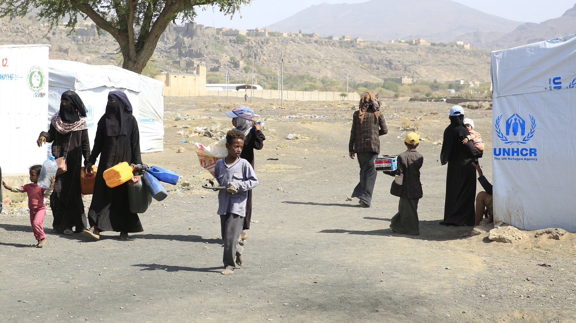 epa10099602 Displaced Yemenis walk through a camp for Internally Displaced Persons (IDPs) amid a UN-brokered nationwide truce, on the outskirts of Sana&#039;a, Yemen, 30 July 2022 (issued 31 July 2022). UN and US diplomatic efforts underway to have a UN-brokered truce in Yemen extended again on 02 August. The two-month truce entered into force on 02 April 2022 after the Yemeni government and the Saudi-led coalition reached an agreement with their rival, the Houthis. It extended for another two months on 02 June. The truce is the longest pause in fighting Yemen is experiencing since 2015 when the Saudi-UAE-led military coalition launched a military campaign against the Houthis for restoring the Saudi-backed government, causing the internal displacement of 4.3 million Yemenis by March 2022, according to UNICEF estimates.  EPA/YAHYA ARHAB