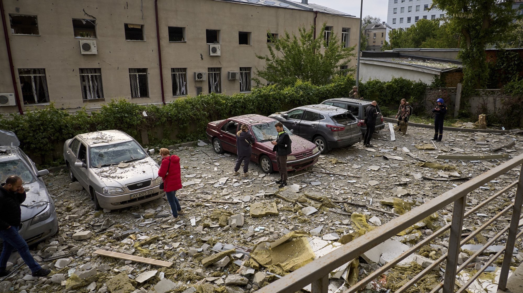 epa11340667 People inspect their cars parked near the site of a shelling in a residential area in Kharkiv, Ukraine, 14 May 2024 amid the Russian invasion.  More than 1000 windows were broken and at least 21 people were wounded including three children in the rocket and glide bomb attacks, according to the mayor of Kharkiv Igor Terekhov. Russian troops entered Ukrainian territory on 24 February 2022, starting a conflict that has provoked destruction and a humanitarian crisis.  EPA/SERGEY KOZLOV 52508