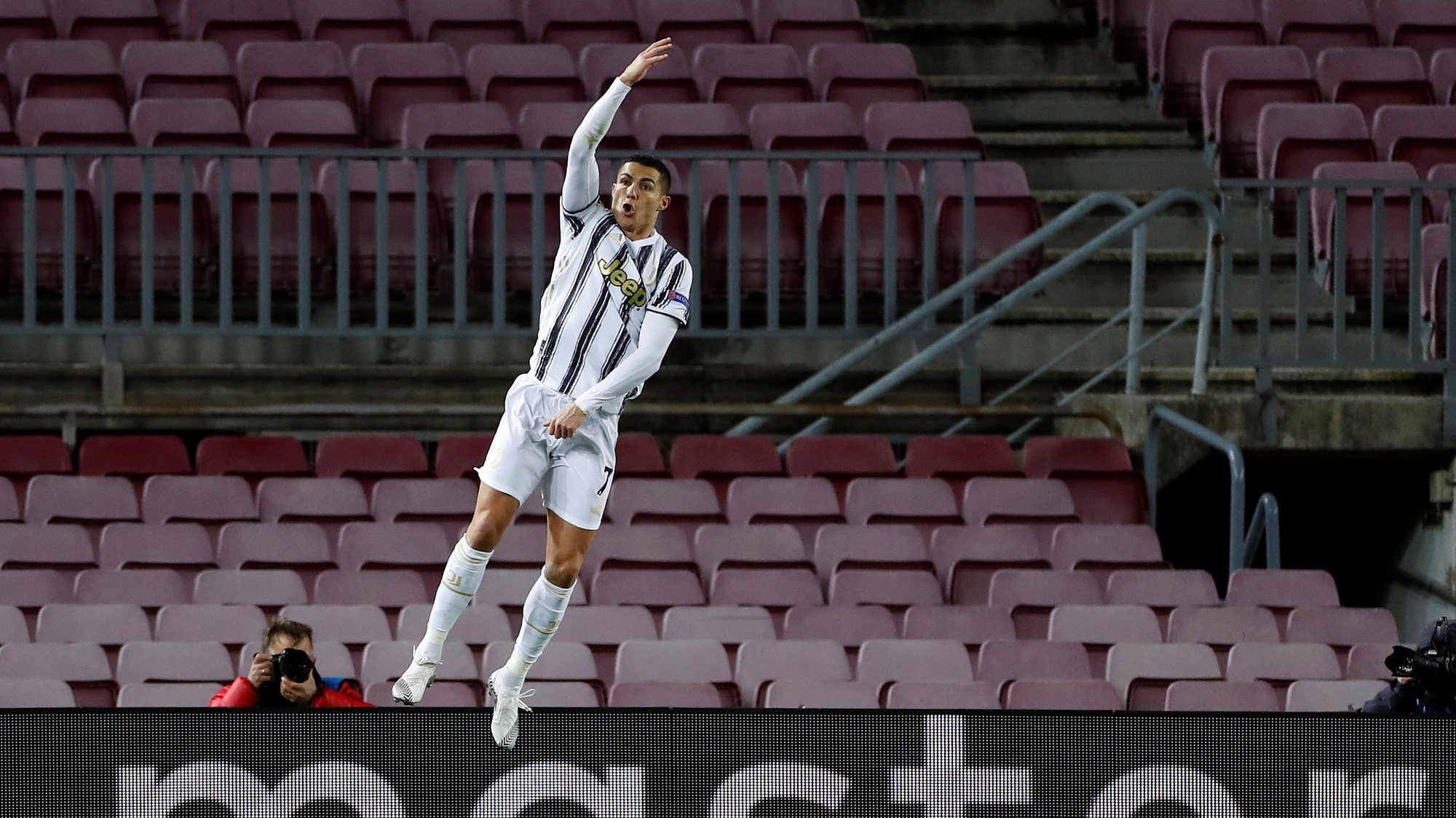 epa08871496 Juventus&#039; striker Cristiano Ronaldo celebrates after scoring the 0-3 from the penalty during the UEFA Champions League group G between FC Barcelona and Juventus at Camp Nou stadium in Barcelona, Catalonia, Spain, 08 December 2020.  EPA/Alberto Estevez