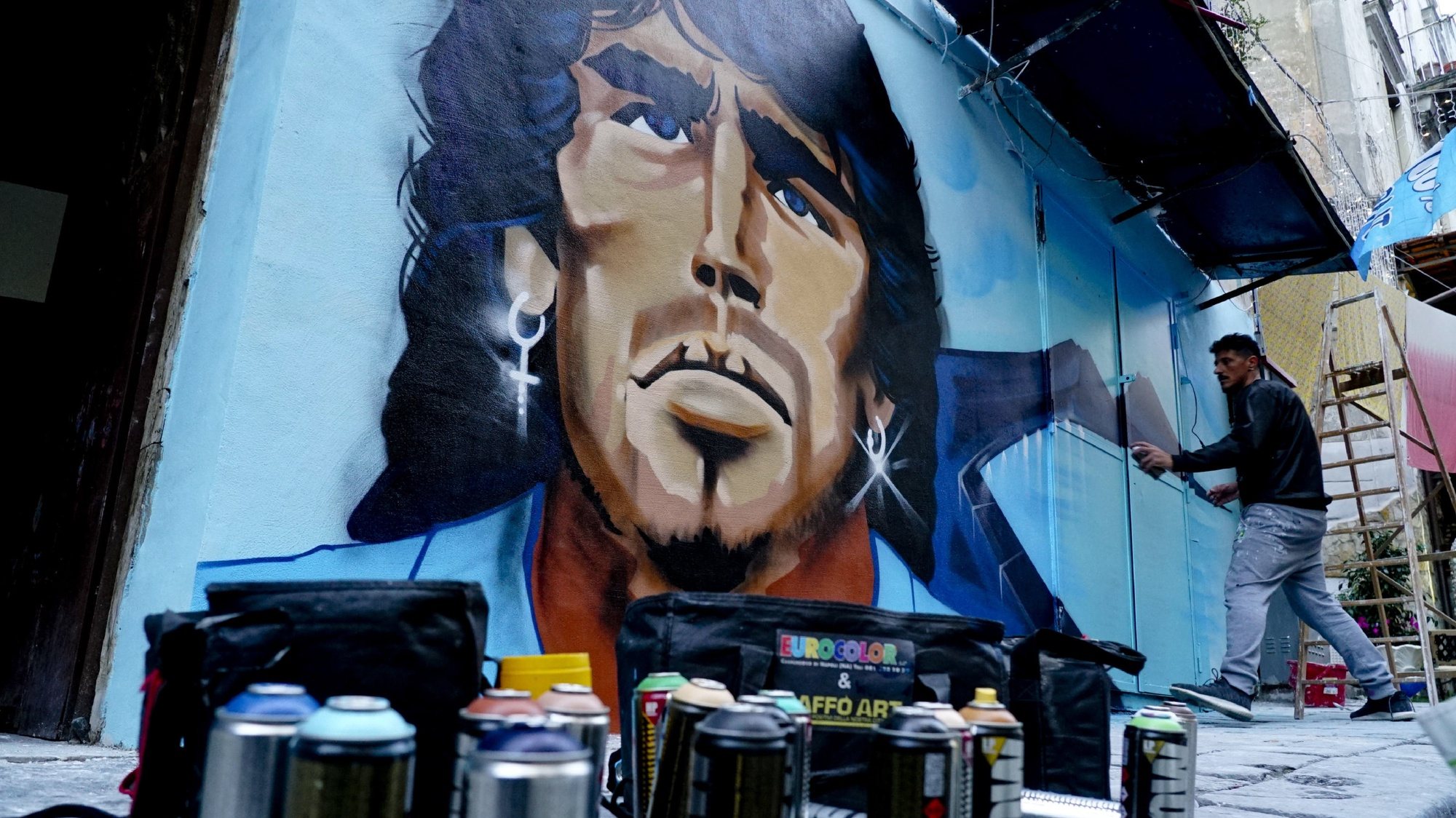 epa08849390 The mural of Diego Armando Maradona created by the writer Raffo Art in the SanitÃ  district in Naples, Italy, 28 November 2020.  EPA/CIRO FUSCO