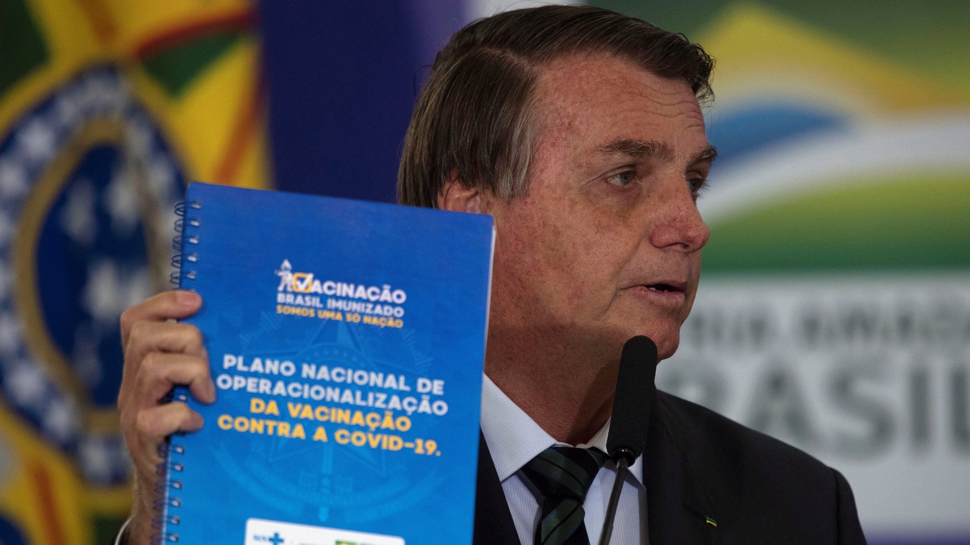 epa08887789 Brazilian President Jair Bolsonaro presents the National Vaccination Plan against covid-19, at the Planalto Palace in Brasilia, Brazil, 16 December 2020. The Brazilian Government presented the master lines of its future vaccination plan against covid-19, which plans to immunize 210 million inhabitants in about 16 months, but has not yet set a start date for the process. According to the Ministry of Health, to establish the day on which the first of the five planned vaccination phases will begin, one must wait for an vaccine to be approved and registered by the National Health Surveillance Agency (Anvisa), which could occur for next February.  EPA/Joedson Alves