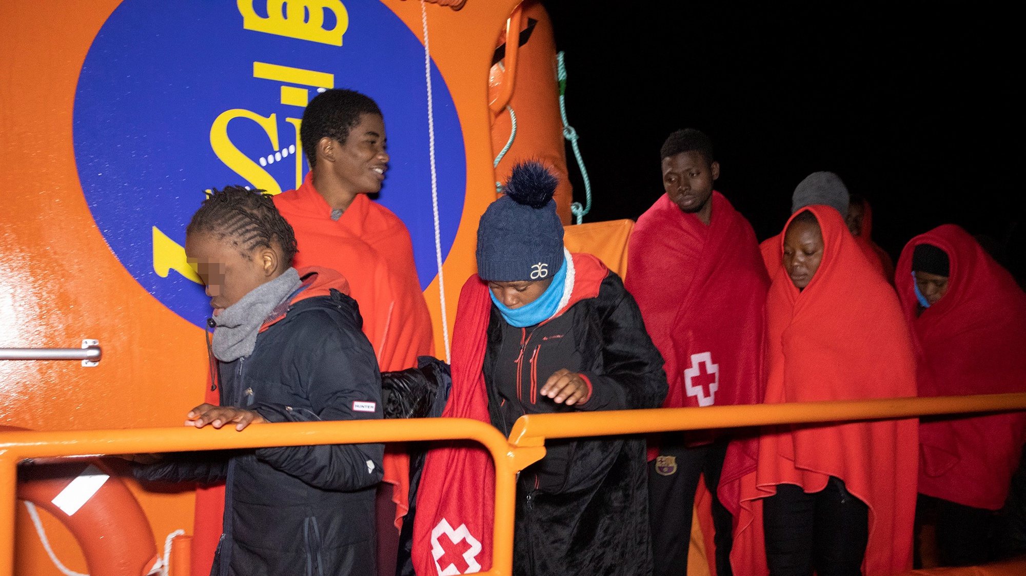 epa08921012 Some of the 44 sub-Saharan migrants disembark at their arrival at Motril&#039;s port after being rescued by Spanish Maritime Safety and Rescue Society when they traveled on board a small boat, in Granada, Spain, 05 January 2020.  EPA/Miguel Paquet