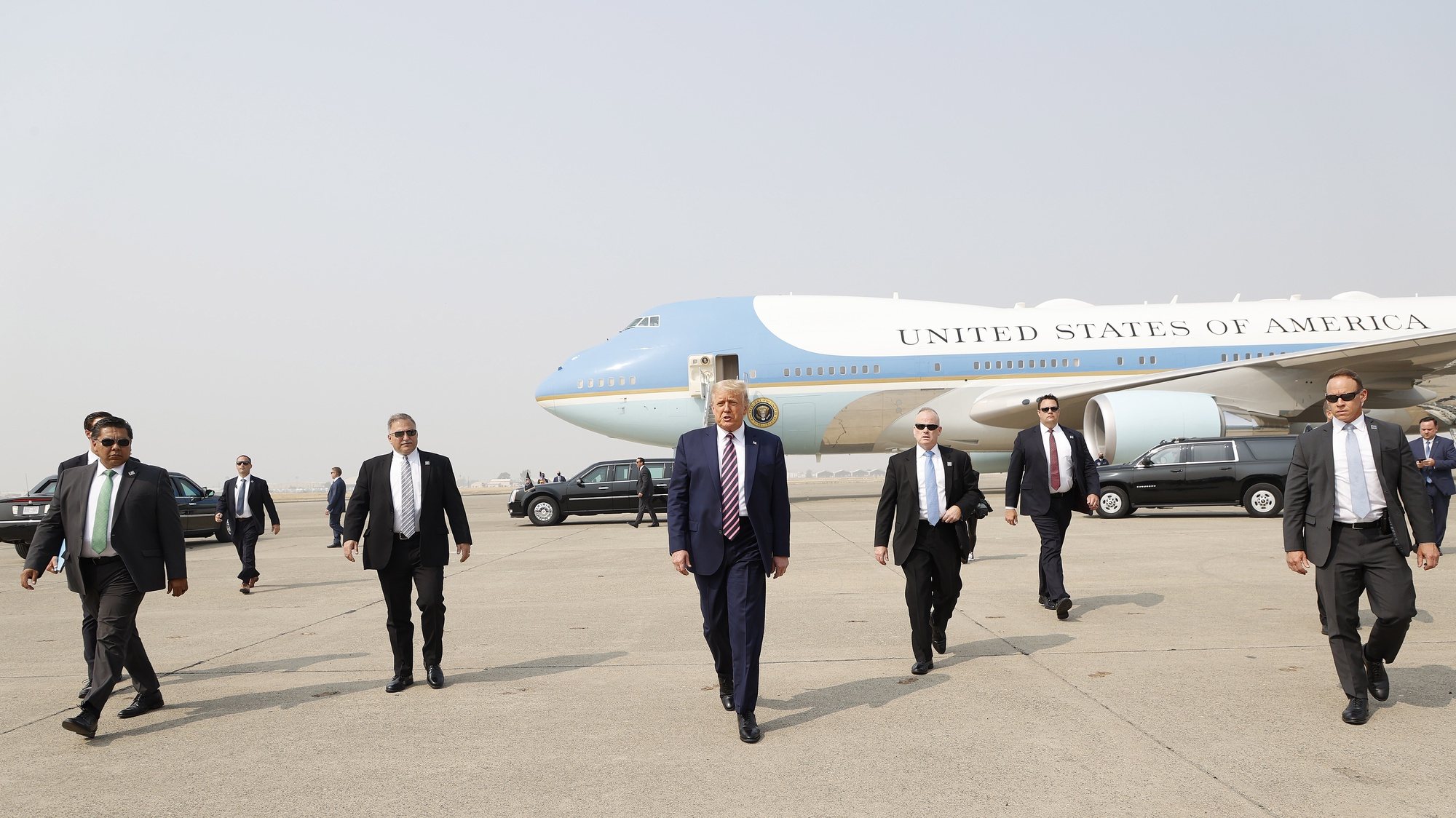 epa08939649 (FILE) US President Donald J. Trump (C) walks towards the media platform surrounded by his secret service detail after arriving on Air Force One at Sacramento McClellan Airport in McClelland Park, California, USA, 14 September 2020. The President visited Sacramento County to be briefed on the deadly wildfires that have burned more than three million acres across California. The presidency of Donald Trump, which records two presidential impeachments, will end at noon on 20 January 2021.  EPA/JOHN G. MABANGLO *** Local Caption *** 56342653