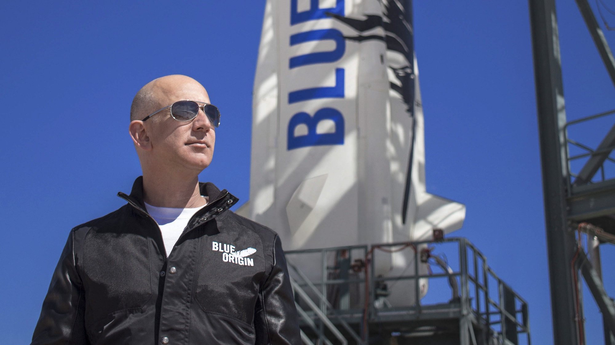 epa09252931 An undated handout photo made available by Blue Origin shows Blue Origin founder Jeff Bezos inspects New Shepard’s West Texas launch facility before the rocket’s maiden voyage, in West Texas, USA. (issued 07 June 2021). Outgoing Amazon CEO Jeff Bezos via social media on 07 June 2021 announced he and his brother will be on Bezos&#039;s space company Blue Origin&#039;s first crewed space flight. One seat on the flight scheduled for 20 July 2021 is auctioned.  EPA/BLUE ORIGIN HANDOUT MANDATORY CREDIT: BLUE ORIGIN HANDOUT EDITORIAL USE ONLY/NO SALES
