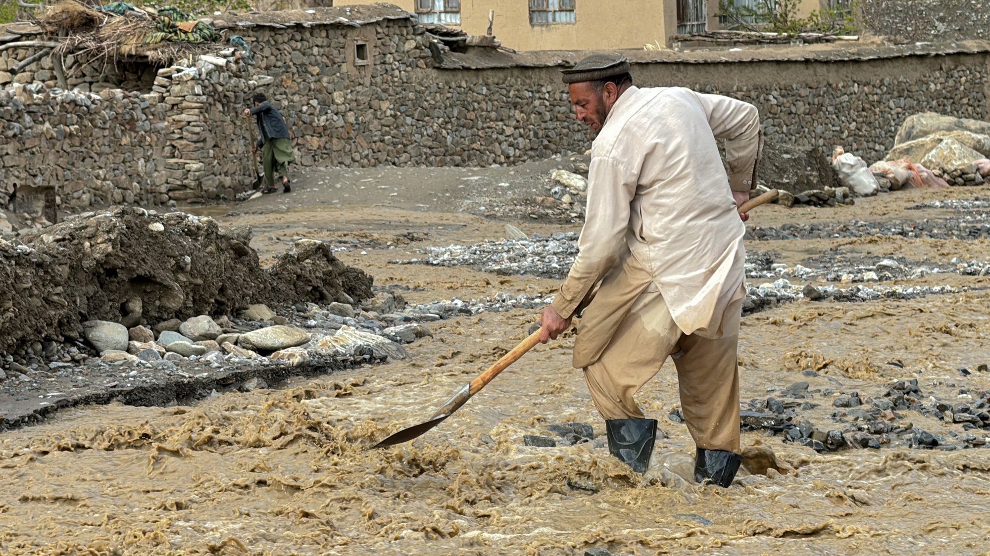 epa11287389 A person shovels stones on a damaged roads following flash floods in Ghorband district of Parwan province, Afghanistan, 18 April 2024. The death toll in incidents related to the heavy rains that have lashed Afghanistan since last week has increased to 50, while 36 have been injured, Ministry for Disaster Management spokesperson Mullah Janan Sayeq said. Heavy rains often cause sudden floods and landslides in the mountainous areas of Afghanistan, due to, among other reasons, poor infrastructure following decades of armed conflict and fragile constructions.  EPA/SHAMRIZ SABAWOON