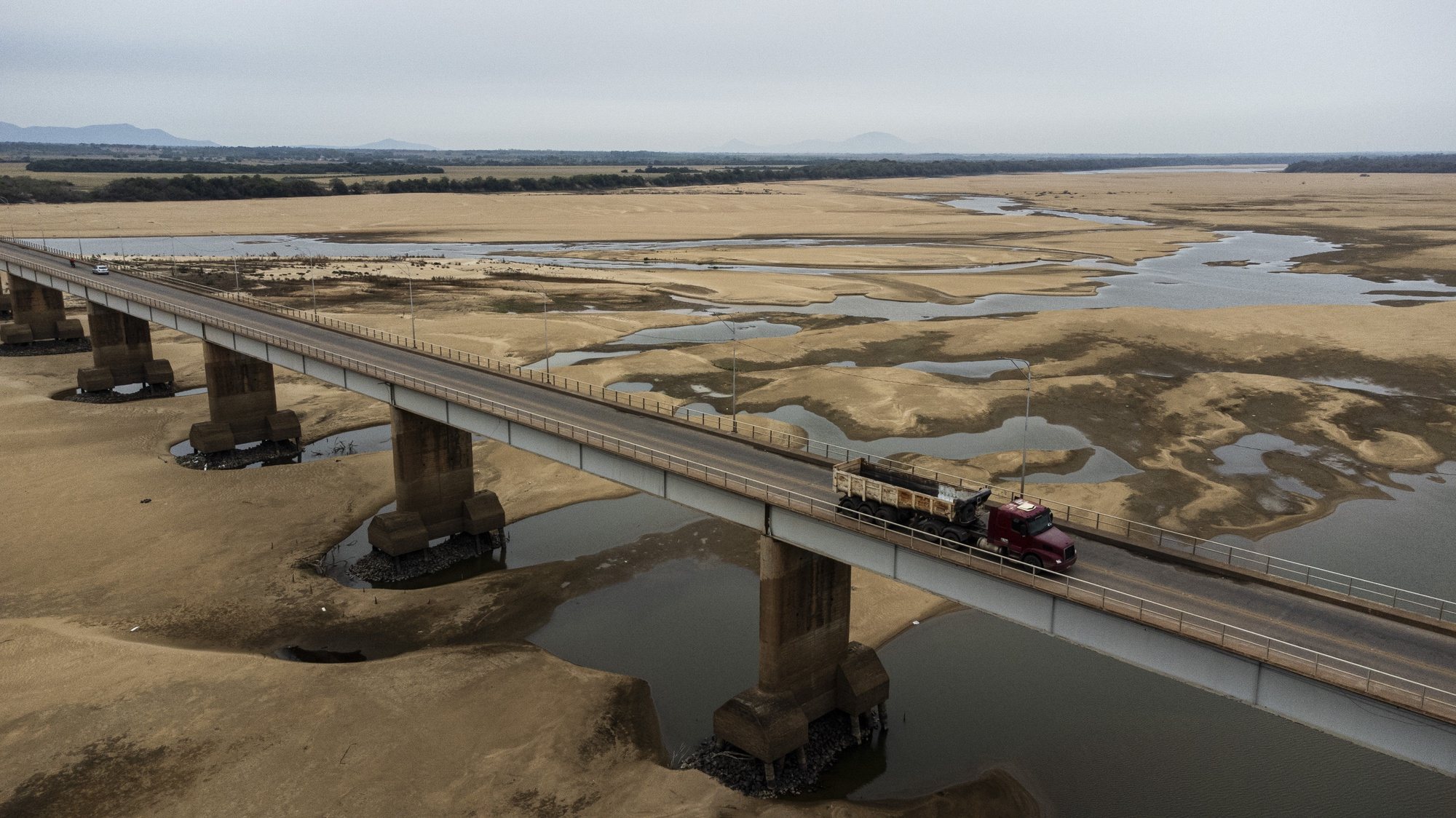 epa11250186 Vehicles cross the Macuxis bridge on the Branco riverbed in Boa Vista, Roraima state, Brazil, 29 March 2024. Drought in the Brazilian Amazon has pushed the flow of the Branco River, one of the region&#039;s largest tributaries, to historic lows at the end of March 2024. The water level reached -39 centimeters earlier in the week, one of the worst records in its history, second only to the 2016 drought, when it reached -59, according to data released by the National Water Agency.  EPA/RAPHAEL ALVES  ATTENTION: This Image is part of a PHOTO SET