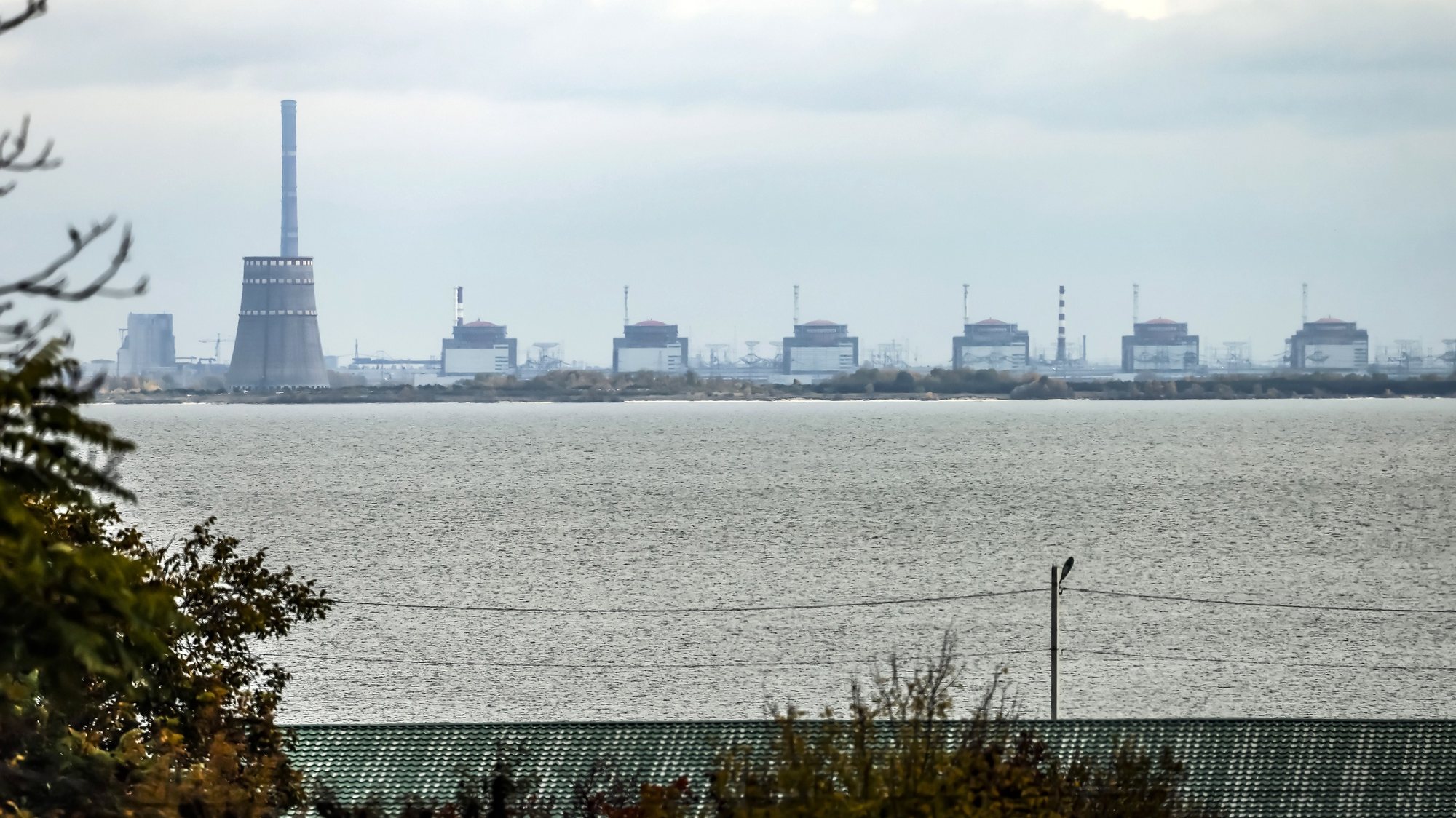 epa10271118 The Zaporizhzhia nuclear power plant (ZNPP) is seen from Nikopol, Ukraine, 28 October 2022. According to a statement by IAEA director general chief Grossi from 28 October 2022, engineers at the ZNPP have been working to stabilize the facility’s external power supplies. The plant has received the power needed to cool the reactors &quot;directly and without interruption from the national grid,&quot; the nuclear watchdog&#039;s chief said. Russian troops on 24 February entered Ukrainian territory, starting a conflict that has provoked destruction and a humanitarian crisis.  EPA/HANNIBAL HANSCHKE