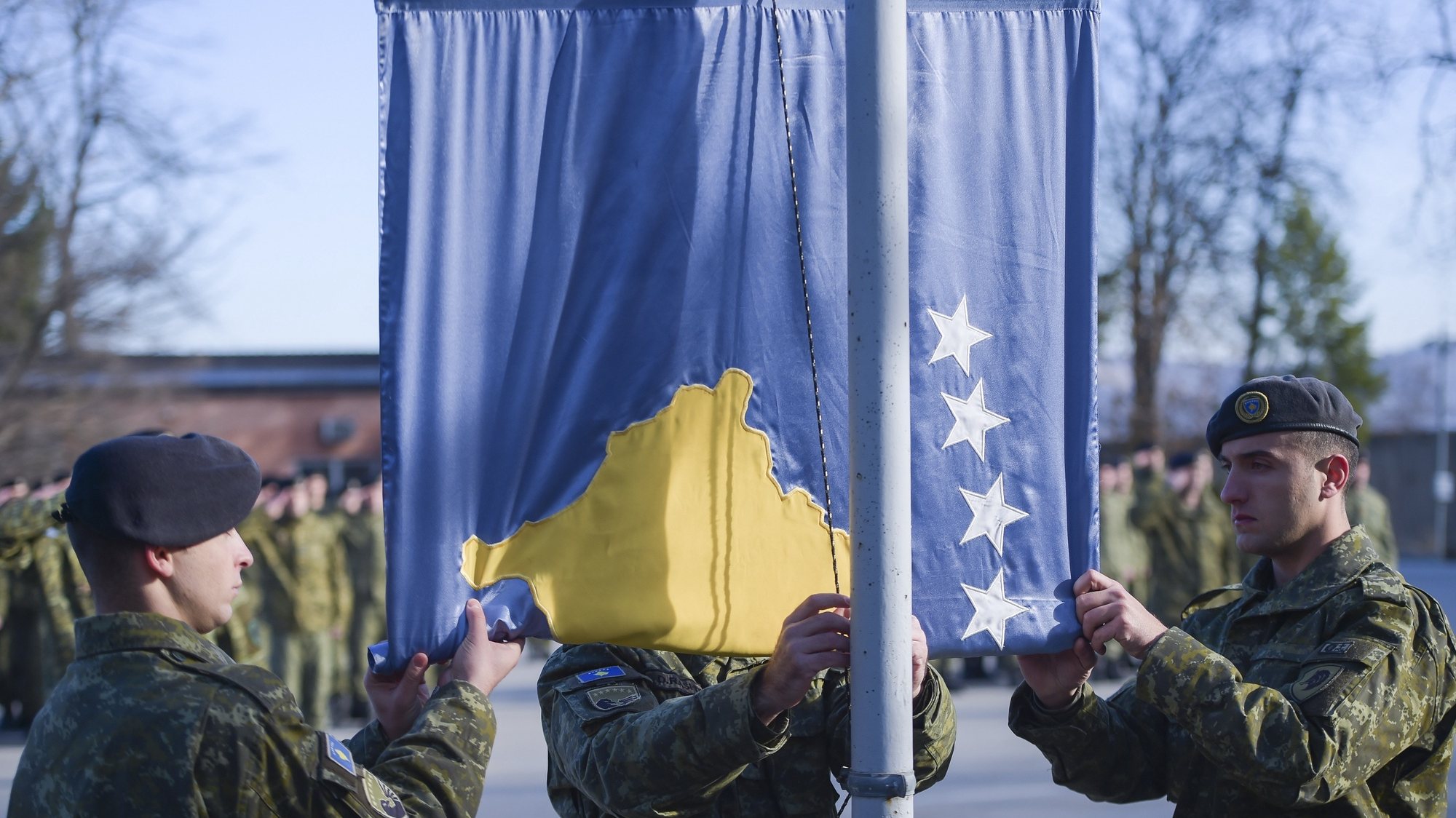 epa07228157 Members of the Kosovo Security Force (KSF) rise the Kosovo national flag before a field training at &#039;New Born&#039; camp in the town of Gjilan, Kosovo, 13 December 2018.  The 120 seat parliament of the Republic of Kosovo is expected to vote for the laws to transform the Security Forces into an official army during the plenary session on 14 December. Parliament in Kosovo, which relies on NATO troops for its protection, voted on 18 October 2018 to set up a 5,000-strong national army though its Serb minority said the move was illegal.  EPA/STRINGER