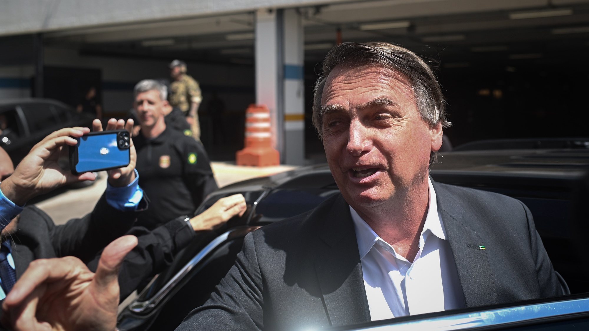 epa10592679 Former president of Brazil Jair Bolsonaro leaves the headquarters of the Federal Police after giving testimony, for the anti-democratic attacks that took place in January, in Brasilia, Brazil, 26 April 2023. Bolsonaro testified for about two hours before the police and denied any responsibility in the coup on January 8, which allegedly tried to overthrow the government of Luiz Inacio Lula da Silva.  EPA/Andre Borges