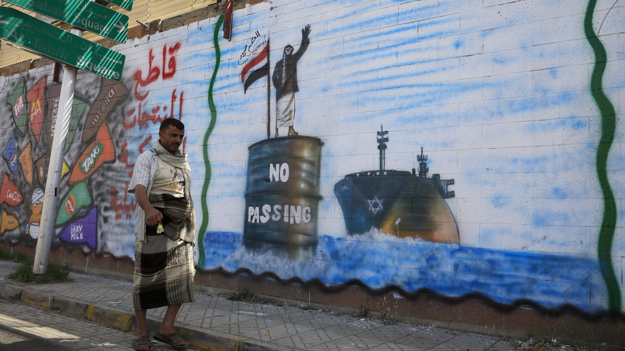 epa11166251 A person walks past a wall with graffiti depicting a Houthi fighter stopping an Israeli ship off the coast of Yemen, in Sana&#039;a, Yemen, 19 February 2024. Yemen&#039;s Houthis have claimed responsibility for a new missile attack on UK-registered cargo ship in the Gulf of Aden off the coast of Yemen, according to a statement by Houthi military spokesman Yahya Sarea. The attack came just a day after the US forces launched five strikes on Houthi targets, including an unmanned underwater vessel. The US designation of Yemen&#039;s Houthis as a &#039;Specially Designated Global Terrorist group&#039; came into effect on 16 February, due to their increased attacks on shipping lanes in the Red Sea and the Gulf of Aden since November 2023. The US Department of Defense announced in December 2023 a multinational operation to safeguard trade and protect ships in the Red Sea in response to the escalation of Houthi attacks.  EPA/YAHYA ARHAB