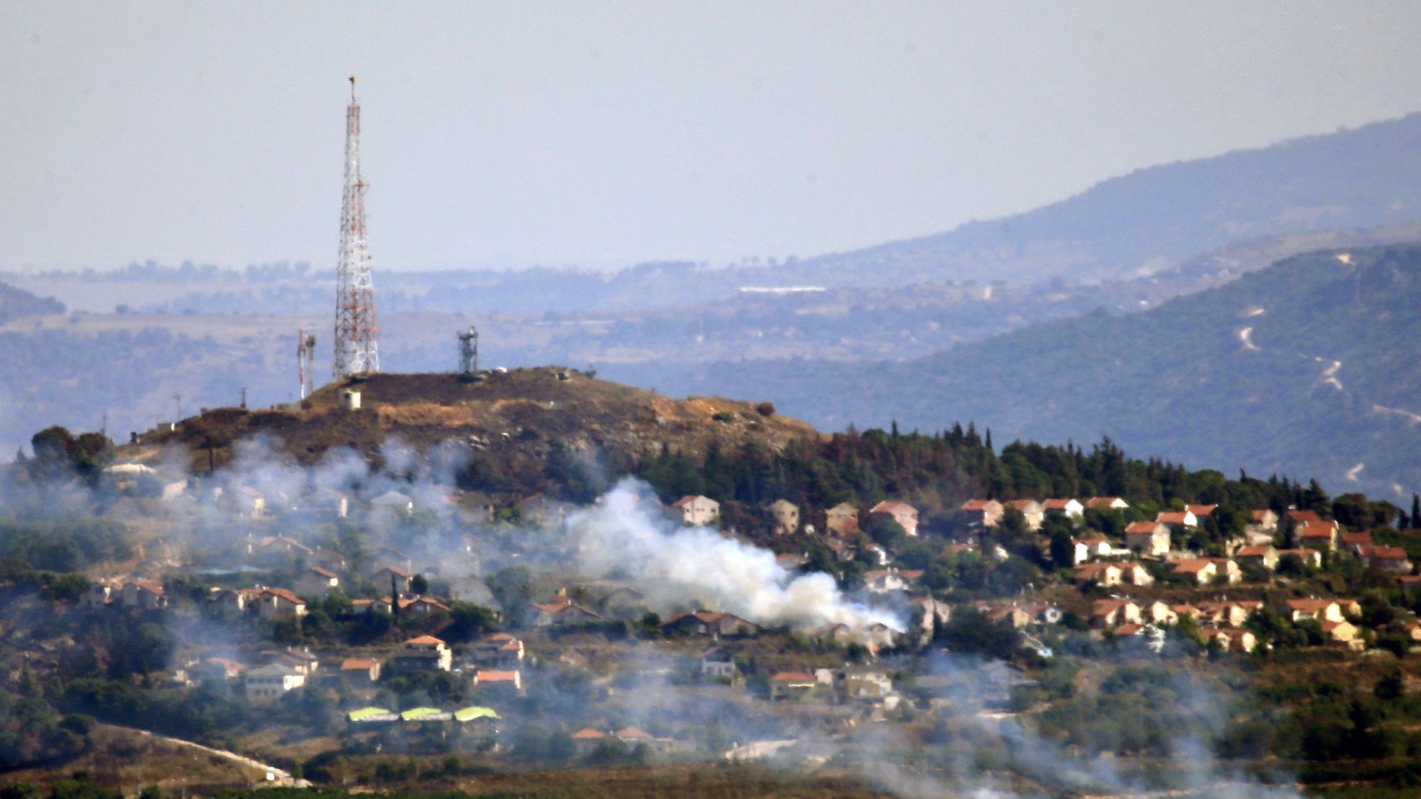epaselect epa11439957 Smoke billows in the Israeli northern town of Metulla from cross-border rockets launched by Hezbollah from the Lebanese side, as seen from Khiam village, Lebanon, 26 June 2024. According to an Israeli army report, the IDF fighter jets on 26 June struck Hezbollah military structure and observation post and other infrastructure in the areas of Kfarchouba, Ayta ash Shab, and Khiam in southern Lebanon. Hezbollah said in statement the group targeted buildings in Metulla with &#039;appropriate weapons&#039; in response to the Israeli attacks on southern villages.  EPA/STR