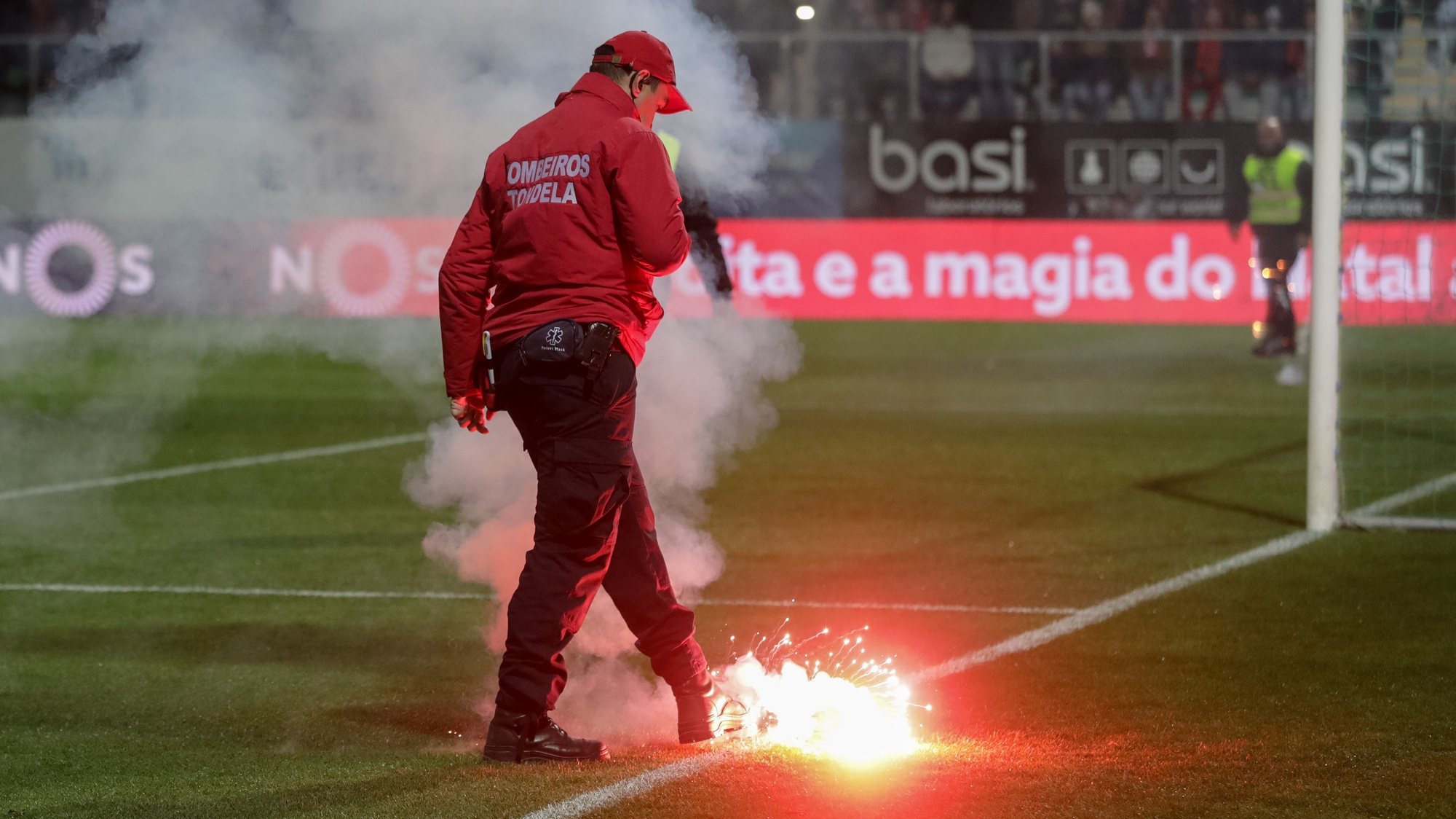 A fireman takes a very-light dropped to the pitch by supporters during the Portuguese First League Soccer match between Tondela and Benfica held at Joao Cardoso Stadium in Tondela, Portugal, 17 December 2017. PAULO NOVAIS/LUSA