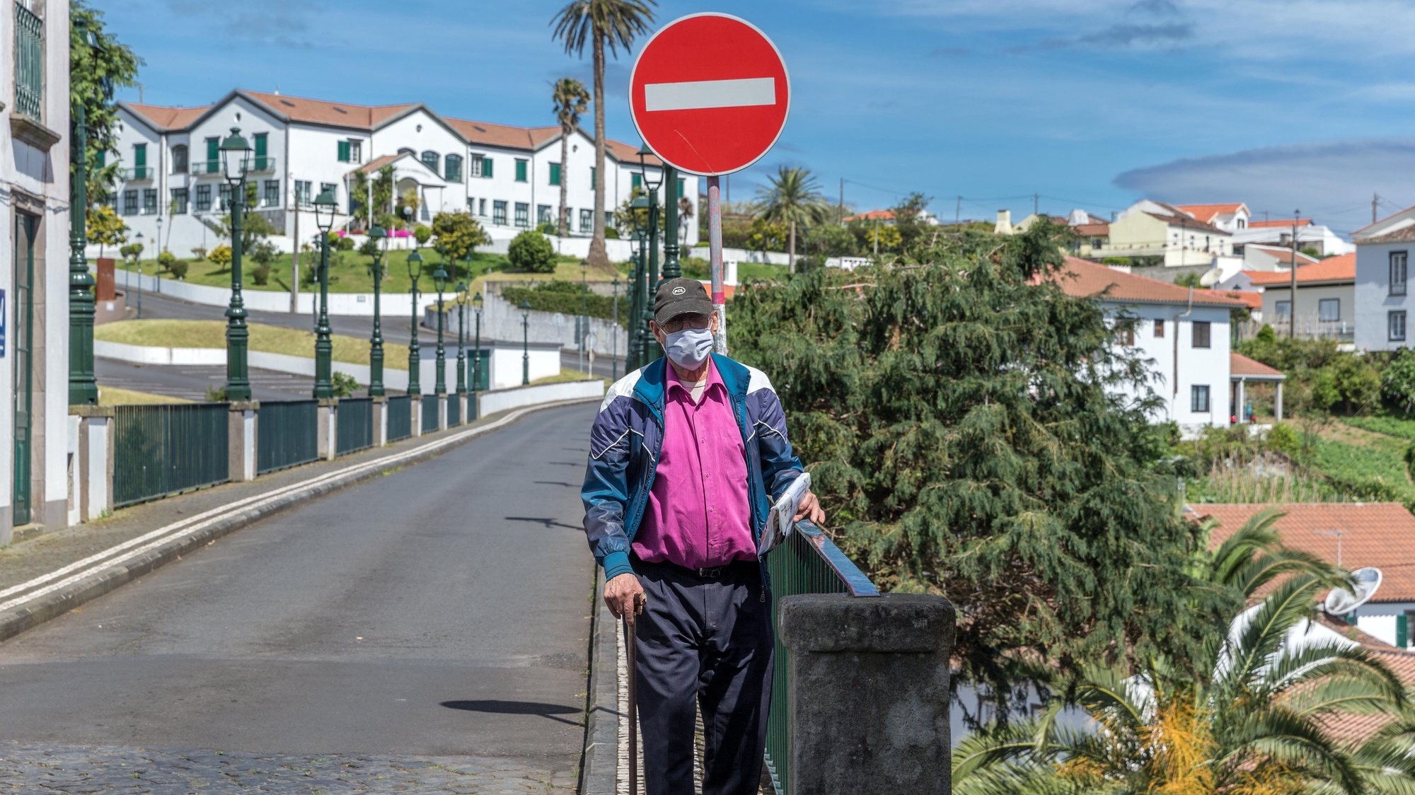 A man protected with a face mask walks on a street in the Nordeste municipality, São Miguel Island, Azores, Portugal, May 18, 2020.  The municipality of Nordeste was the last in the country to leave the sanitary fence because of the covid-19. EDUARDO COSTA /LUSA