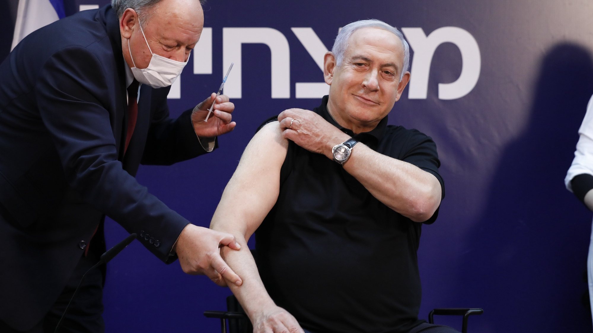 epa08894574 Israeli Prime Minister Minister Benjamin Netanyahu (R) receives a coronavirus disease (COVID-19) vaccine at Sheba Medical Center in Ramat Gan, Israel, 19 December 2020.  EPA/AMIR COHEN / POOL