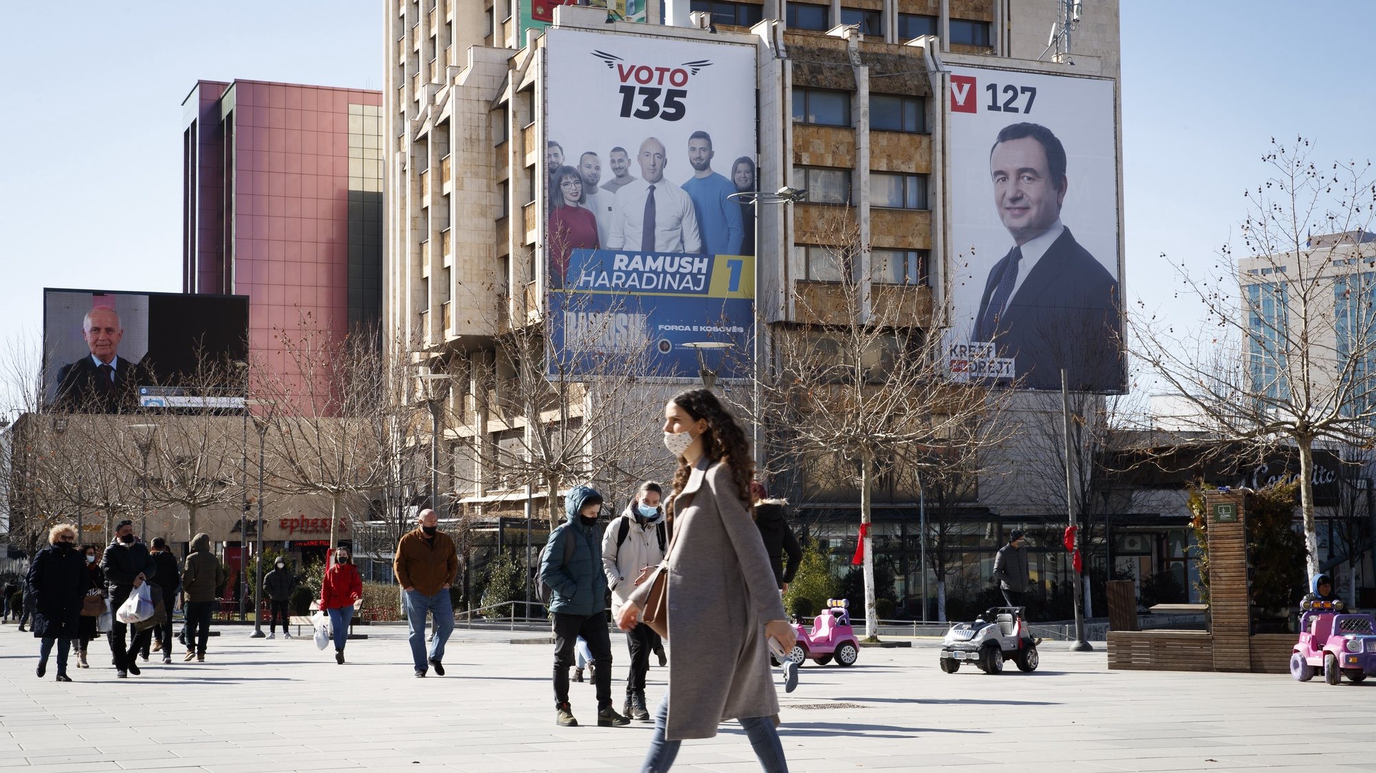 epa09006789 Pedestrians walk in front of the giant electoral posters showing the leader of the movement Self-determination (Vetevendoje) Albin Kurti (R) and leader of the Alliance for the Future of Kosova (AAK) Ramush Haradinaj (L) in Pristina, Kosovo, 12 February 2021. Kosovo&#039;s early parliamentary elections will be held on 14 February 2021.  EPA/VALDRIN XHEMAJ