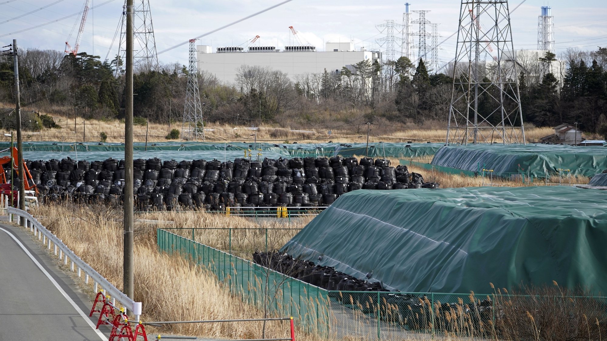 epa09053299 Bags containing contaminated soil and debris are pilled up near the crippled Fukushima Daiichi Nuclear Power Plant in Okuma, Fukushima prefecture, Japan, 17 February 2021 (issued 05 March 2021). More than 36,000 people who evacuated Fukushima after the nuclear accident are still away from their homes 10 years later, and most of them don&#039;t want to go back due to radiation concerns, which remains one of the main challenges in the decades-lasting reconstruction process.  EPA/FRANCK ROBICHON  ATTENTION: This Image is part of a PHOTO SET