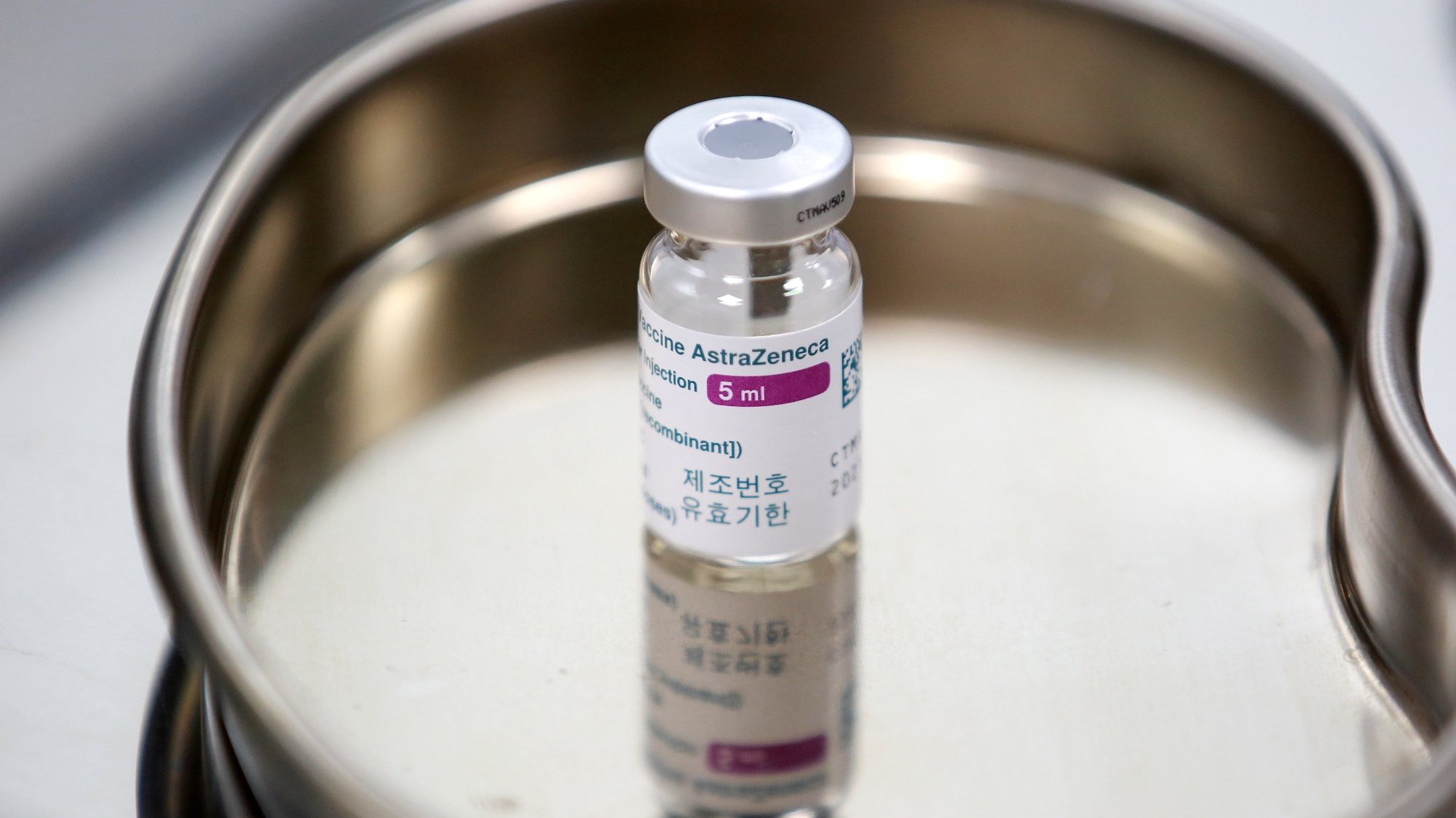 epa09079044 A vial of COVID-19 vaccine developed by AstraZeneca sits on a tray at a vaccination center of the Vietnam Vaccine Joint Stock Company (VNVC), in Hanoi, Vietnam 17 March 2021. Major European countries have temporarily suspended the use of the AstraZeneca jab following reports of side effects such as blood clots.  EPA/LUONG THAI LINH