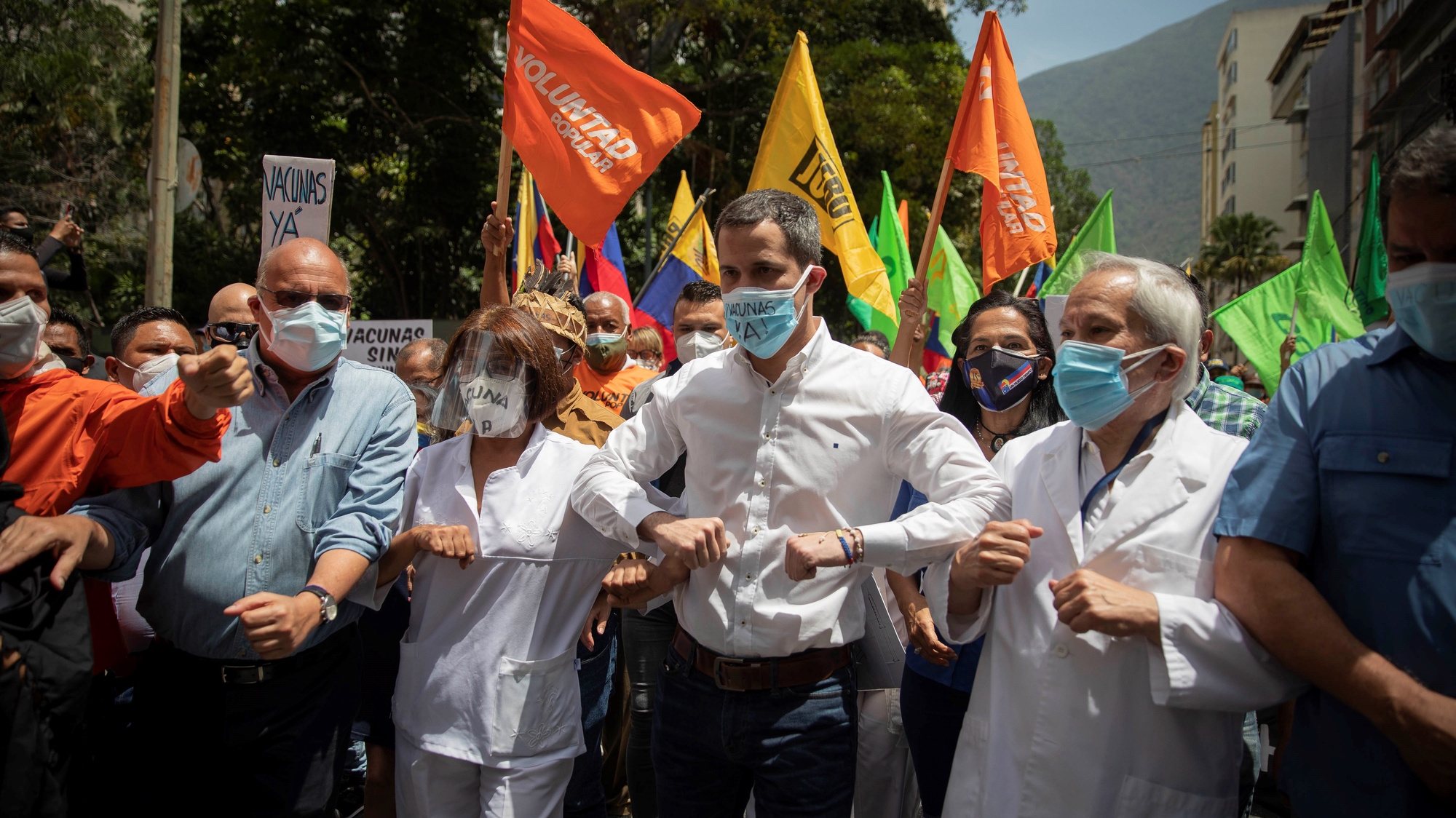 epa09142025 Venezuelan opposition leader Juan Guaido participates in a health workers march calling on authorities for providing COVID-19 vaccines in Caracas, Venezuela, 17 April 2021. Health workers and opposition leaders in Venezuela marched together, claiming a COVID-19 vaccination plan &#039;without political bias&#039; and placing health workers handling coronavirus patients first.  EPA/RAYNER PENA