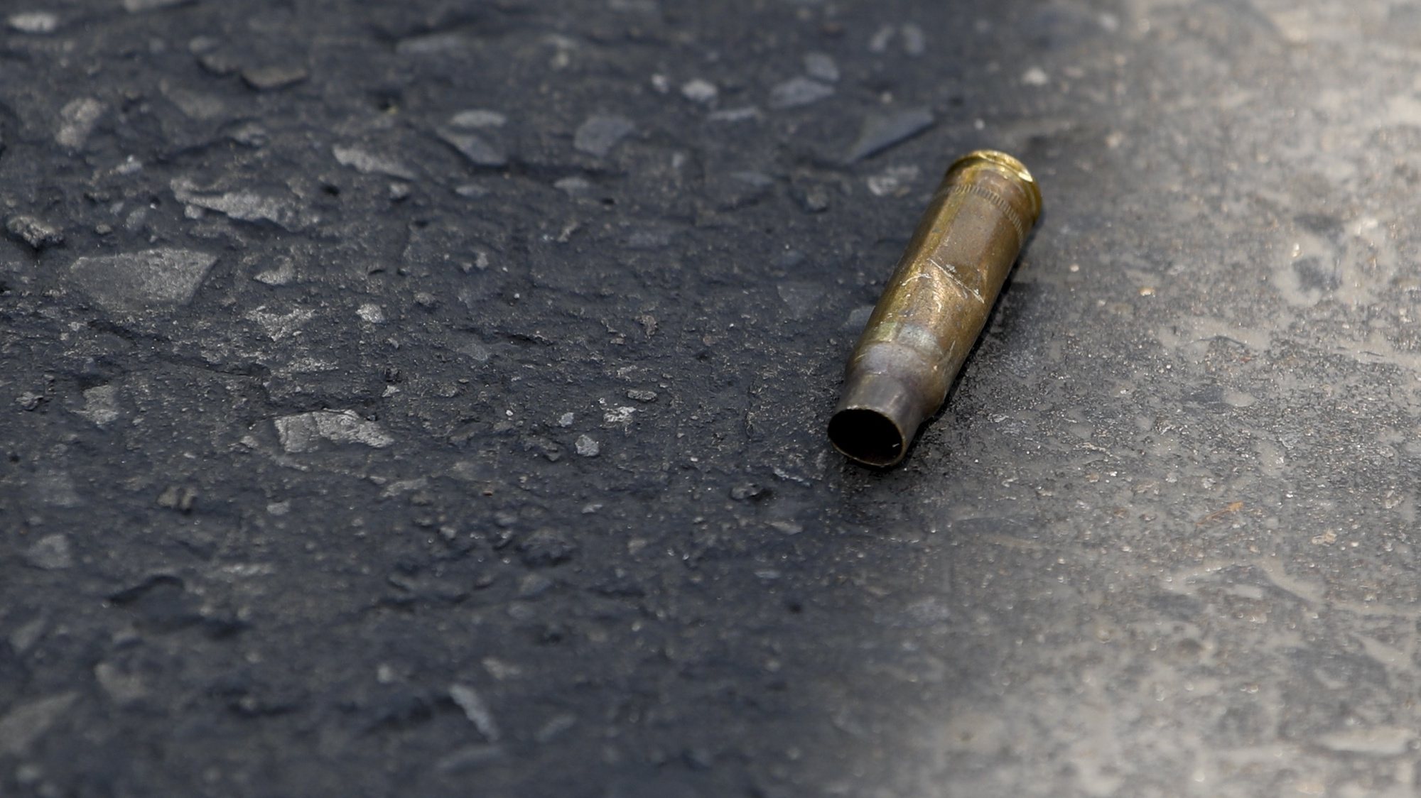 epa08204489 A bullet shell is seen on the street at the scene of a mass shooting at the Terminal 21 shopping mall in Nakhon Ratchasima, Thailand, 09 February 2020. According to media reports, at least 21 people were killed, and as many as 40 wounded after a Thai soldier, identified as 32-year-old Jakraphanth Thomma, went on a shooting rampage with a M60 machine gun in the city of Nakhon Ratchasima, also known as Korat. Thomma held an unknown number of people hostage within the Terminal 21 shopping mall for around 15 hours before being shot and killed in a police operation.  EPA/RUNGROJ YONGRIT