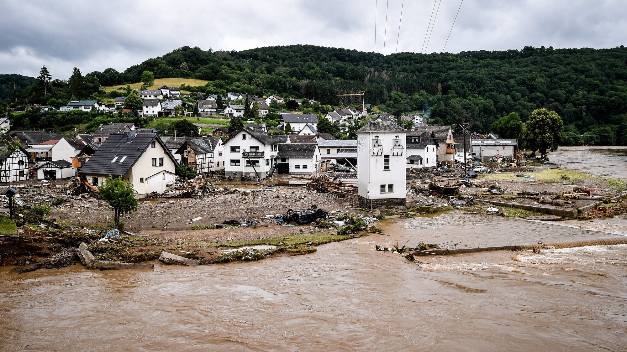 epa09345975 The village of Schuld in the district of Ahrweiler is destroyed after heavy flooding of the river Ahr, in Schuld, Germany, 15 July 2021. Large parts of Western Germany were hit by heavy, continuous rain in the night to Wednesday, resulting in local flash floods that destroyed buildings and swept away cars.  EPA/SASCHA STEINBACH