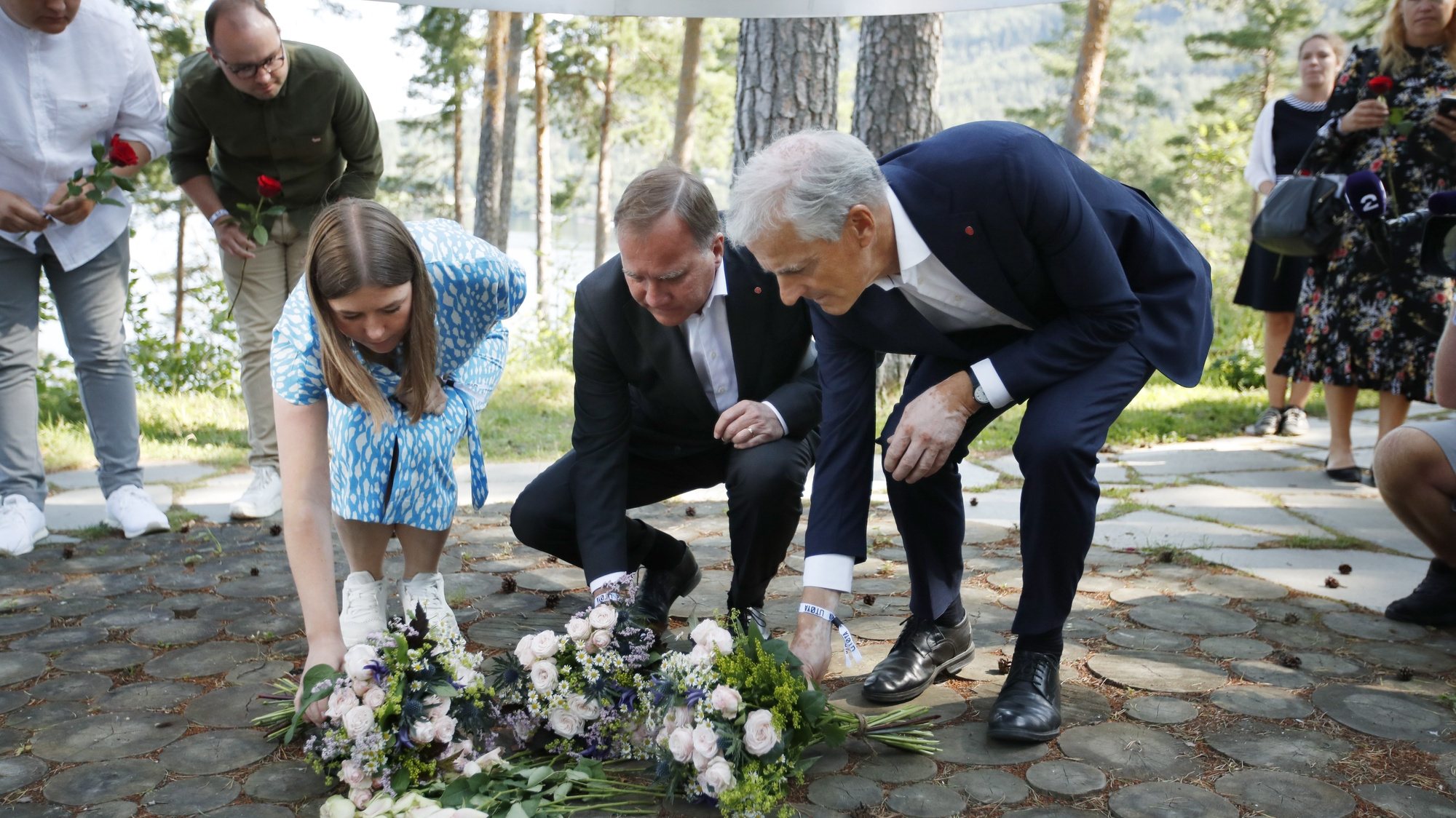 epa09356447 Leader of AUF in Norway, Astrid Hoem, Prime Minister of Sweden Stefan Loefven and leader of the Norwegian Labor Party Jonas Gahr Store lay flowers at the memorial on Utoya the day before the 10th anniversary of the terrorist attack on 22 July 2011. Norway marks 10 years since 22 July 2011, when 77 people were killed by an act of terrorism, eight in the governmental quarters in Oslo, and 69 at the Social Democratic Youth party&#039;s summer camp on the island of Utoya.  EPA/BEATE OMA DAHLE  NORWAY OUT