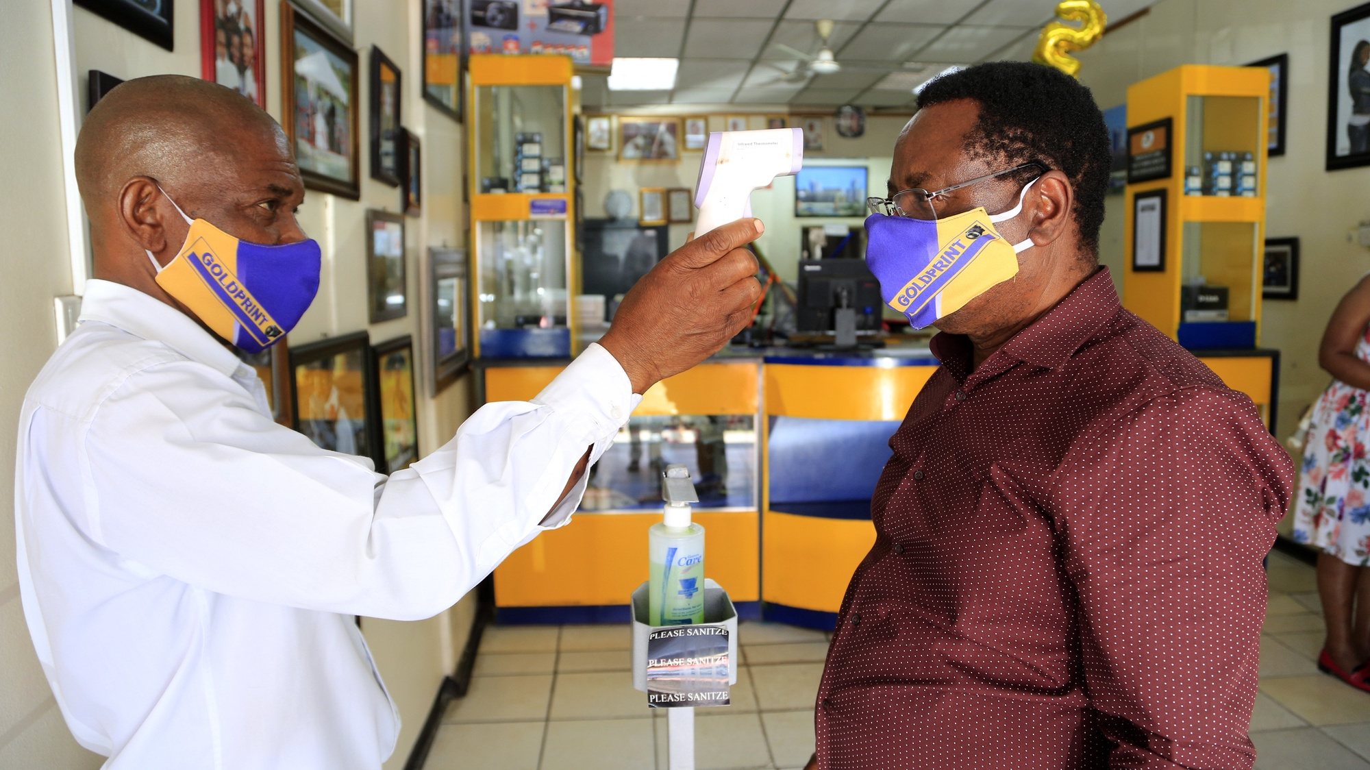 epa08757350 A man has his skin temperature checked in a shop Harare, Zimbabwe, 19 October 2020. According to the World Health Organisation (WHO), Africa faces a reality check in its fight against the coronavirus pandemic as cases and deaths rise after easing lockdowns and travel restrictions. The continent has seen an increase in weekly Covid-19 cases.  EPA/AARON UFUMELI
