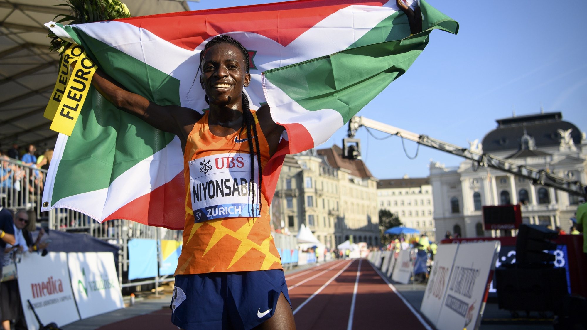 epa09455465 Francine Niyonsaba of Burundi celebrates after winning the women&#039;s 5,000m race during the city event of the Weltklasse IAAF Diamond League international athletics meeting on Sechselaeutenplatz in Zurich, Switzerland, 08 September 2021.  EPA/JEAN-CHRISTOPHE BOTT