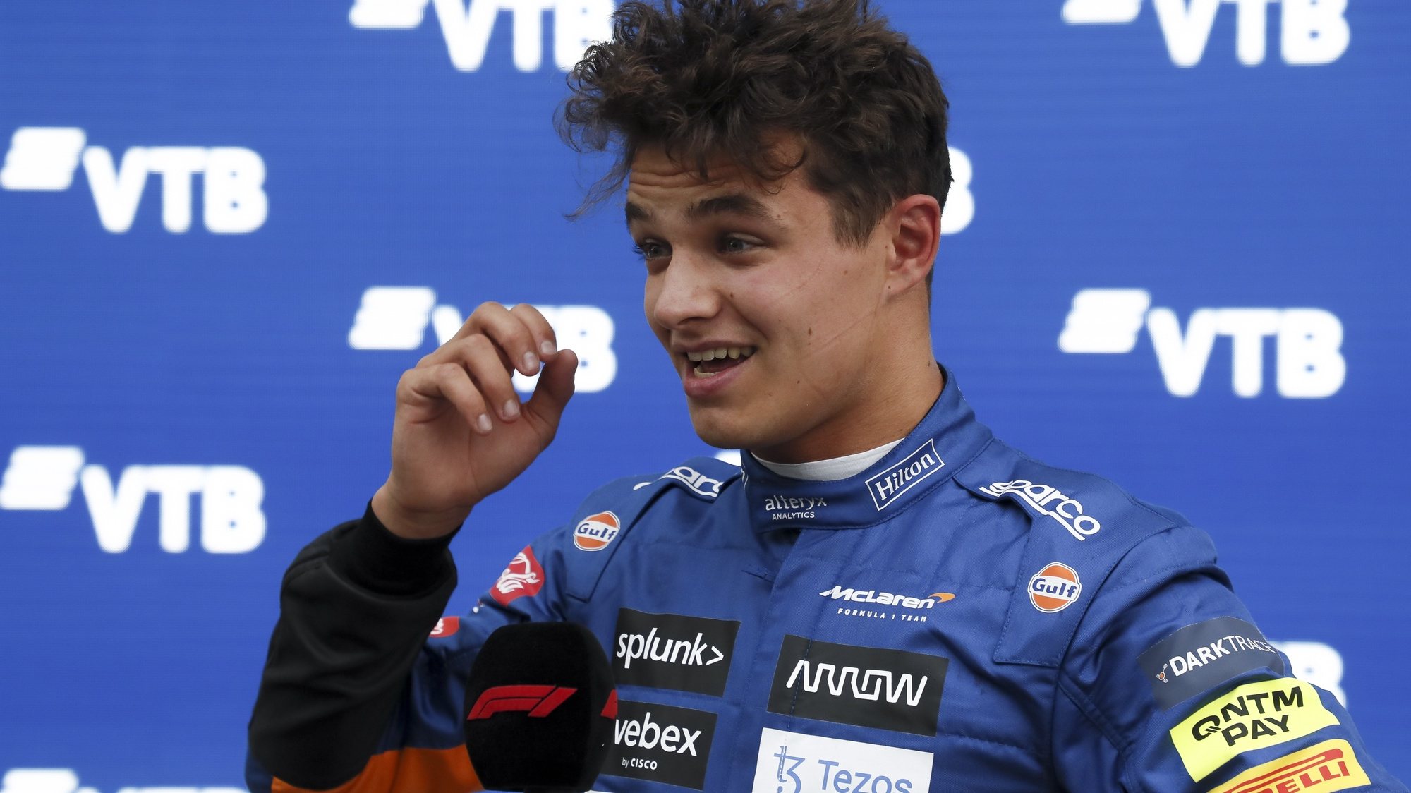 epa09487538 British Formula One driver Lando Norris of the McLaren F1 Team reacts after taking the pole position in the qualifying session of the 2021 Formula One Grand Prix of Russia at the Sochi Autodrom race track in Sochi, Russia, 25 September 2021. The Formula One Grand Prix of Russia will take place on 26 September 2021.  EPA/Yuri Kochetkov / POOL